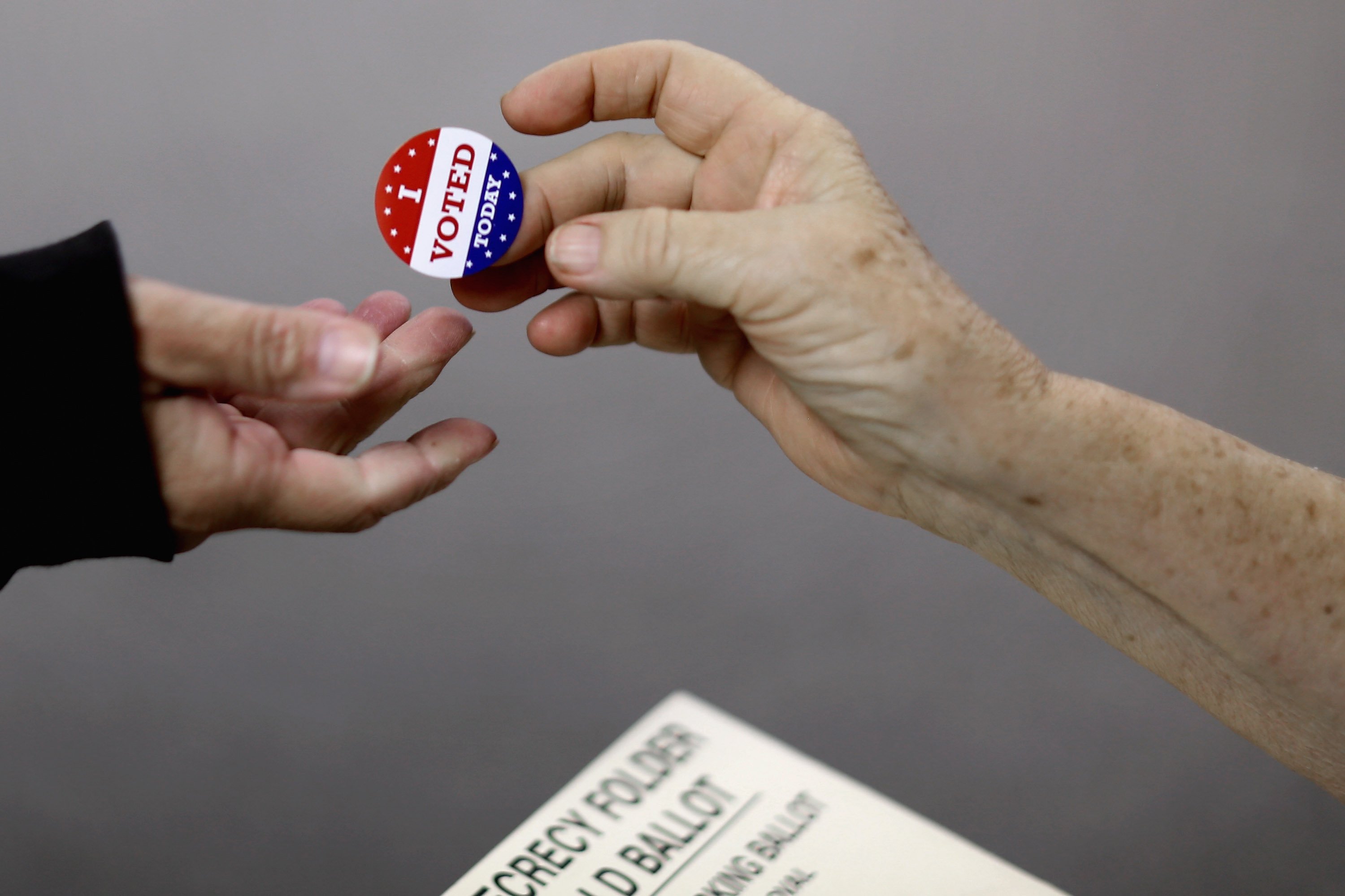 Voters get an 'I VOTED TODAY' sticker after casting their ballots on election day at the Red Oak Fire Department on Nov. 4, 2014 in Red Oak, Iowa. (Chip Somodevilla—Getty Images)