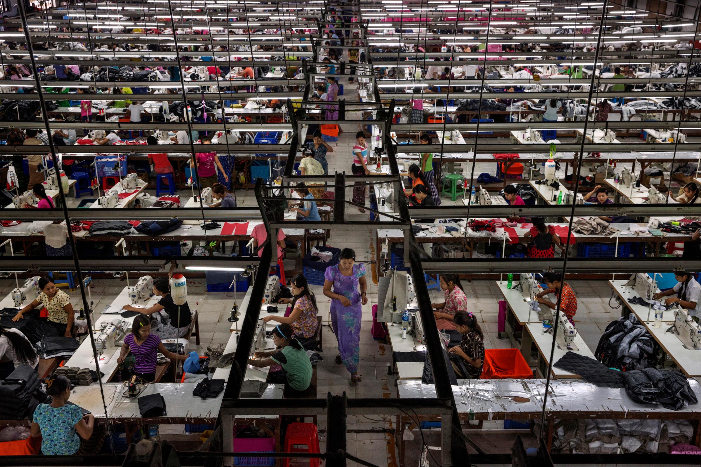 Workers make clothes for export  at a factory in Yangon, Burma, Sept. 18, 2014.