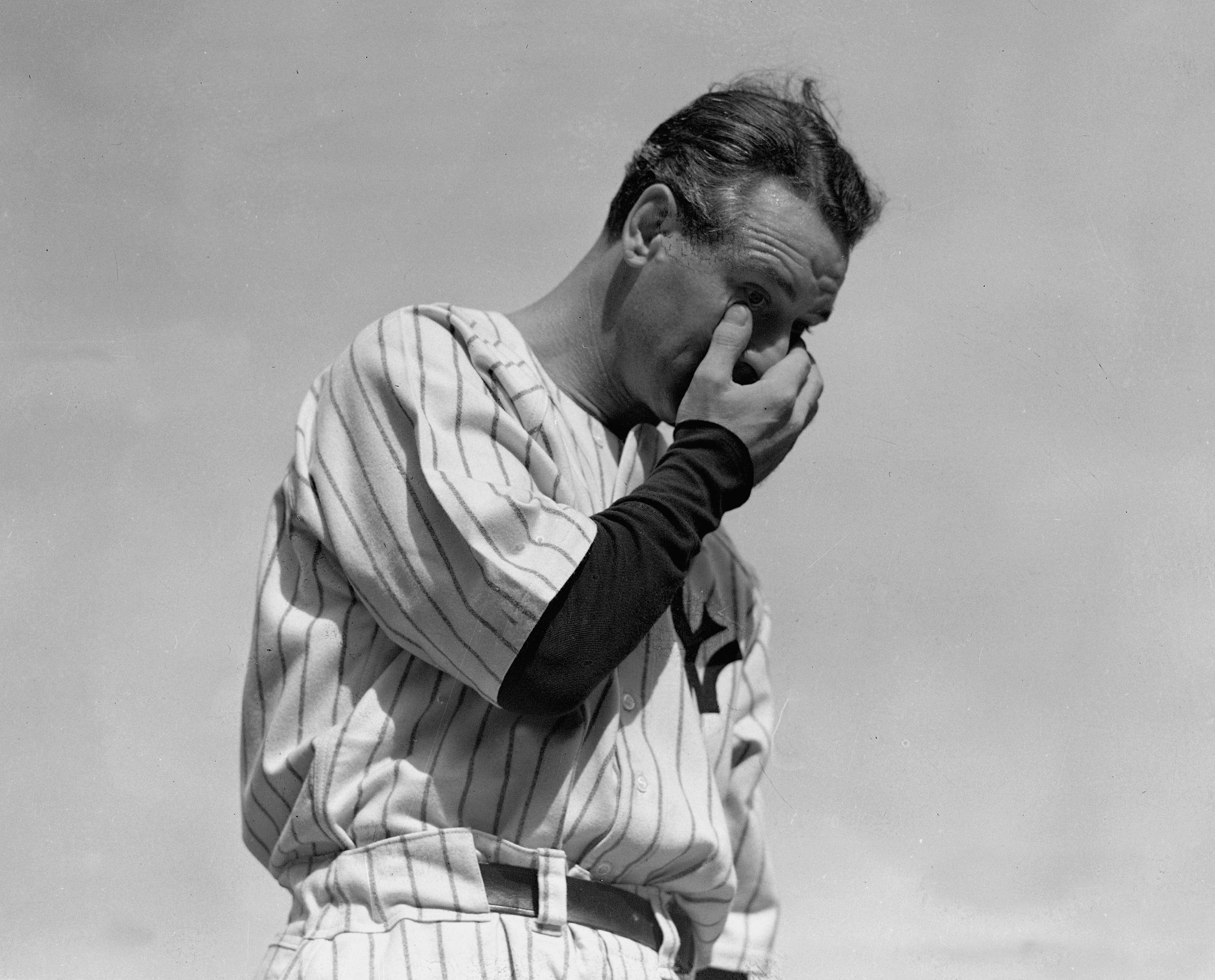 New York Yankees' Lou Gehrig wipes away a tear while speaking during a sold-out tribute at Yankee Stadium on July 4, 1939.