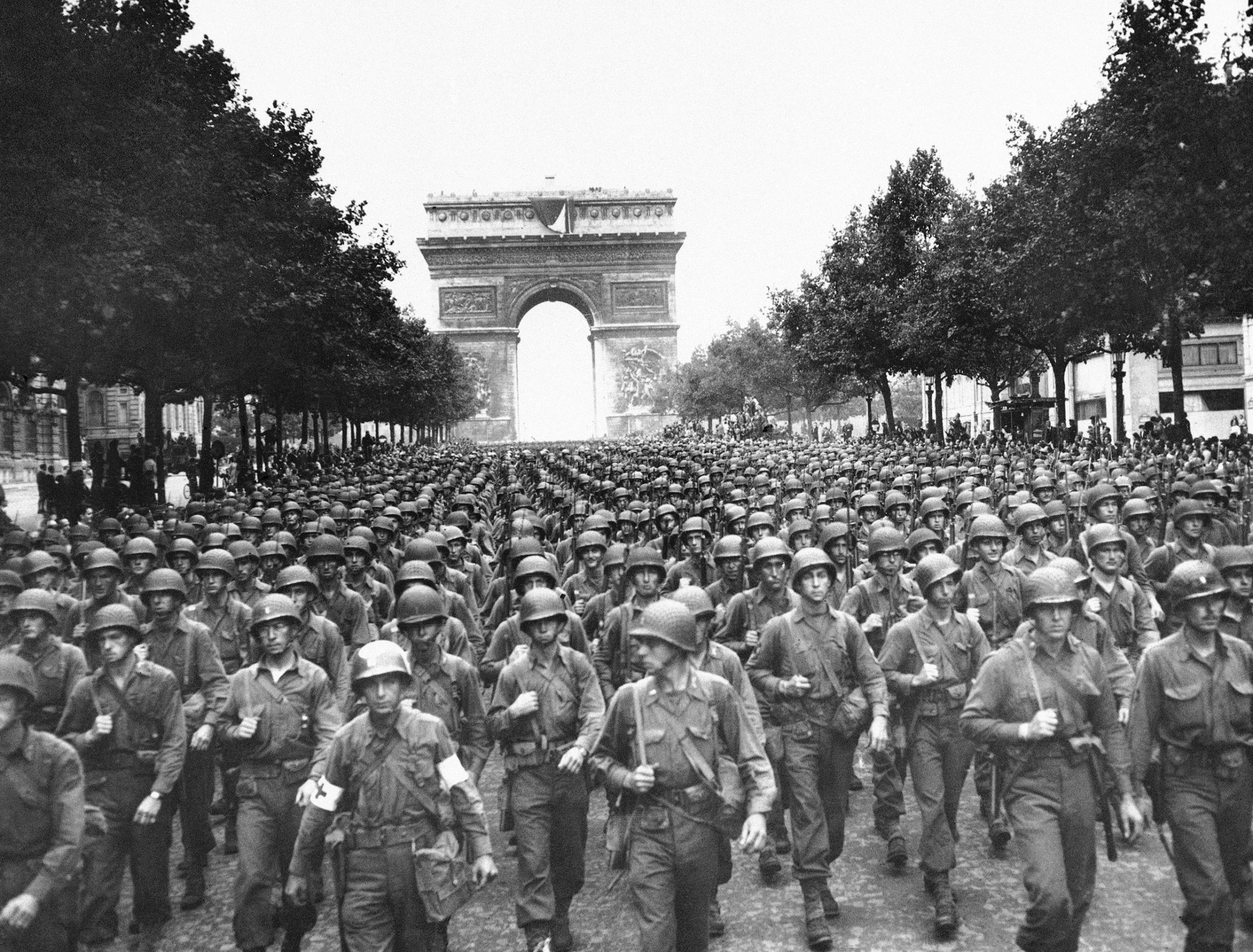 U.S. soldiers of Pennsylvania's 28th Infantry Division march along the Champs Elysees, the Arc de Triomphe in the background, on Aug. 29, 1944, four days after the liberation of Paris during WWII.