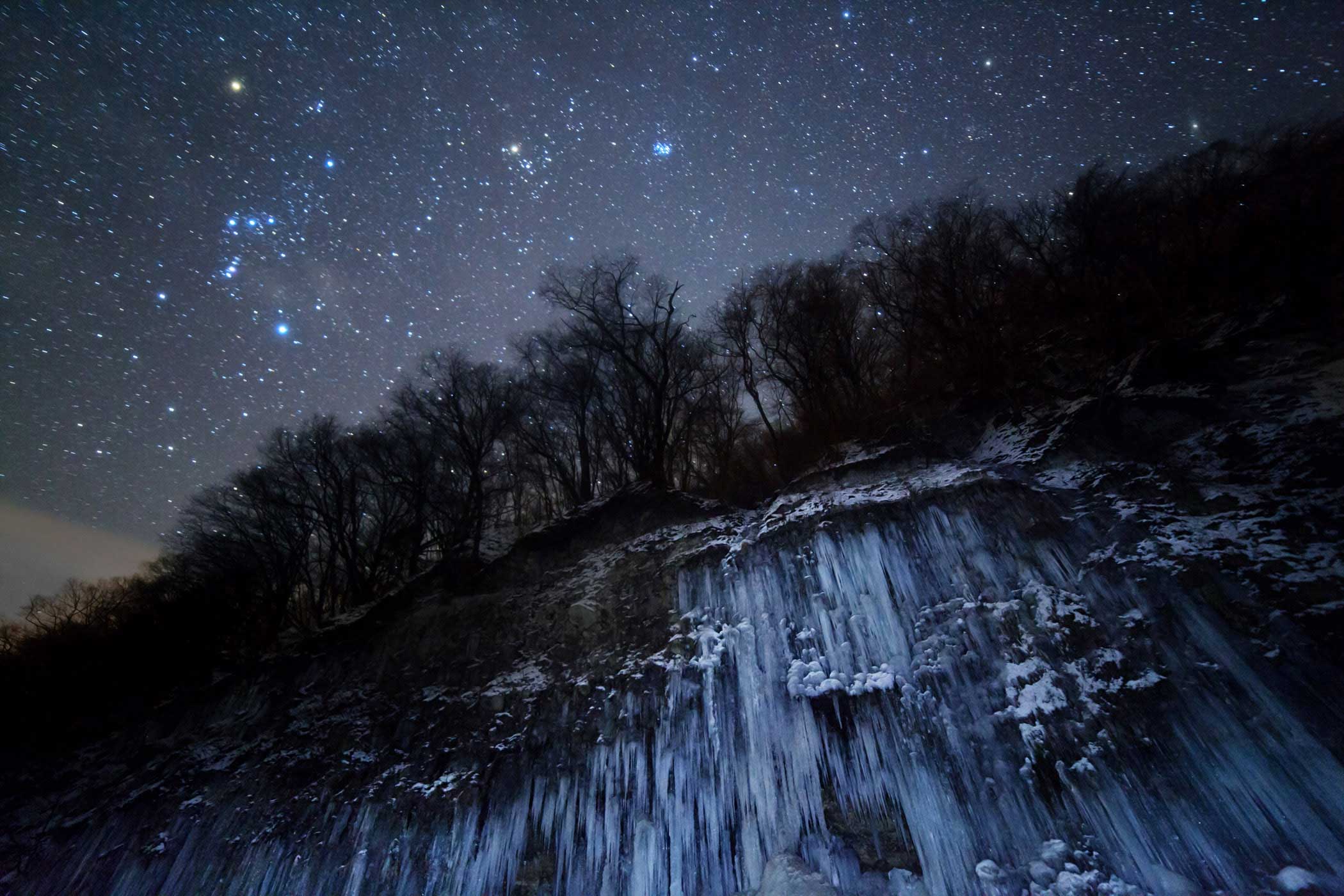 Taken in Nagano, Japan, this image shows Orion, Taurus and the Pleiades as the backdrop to an eerie frozen landscape. Though the stars appear to gleam with a cold, frosty light, bright blue stars like the Pleiades can be as hot as 30,000 degrees Celsius.