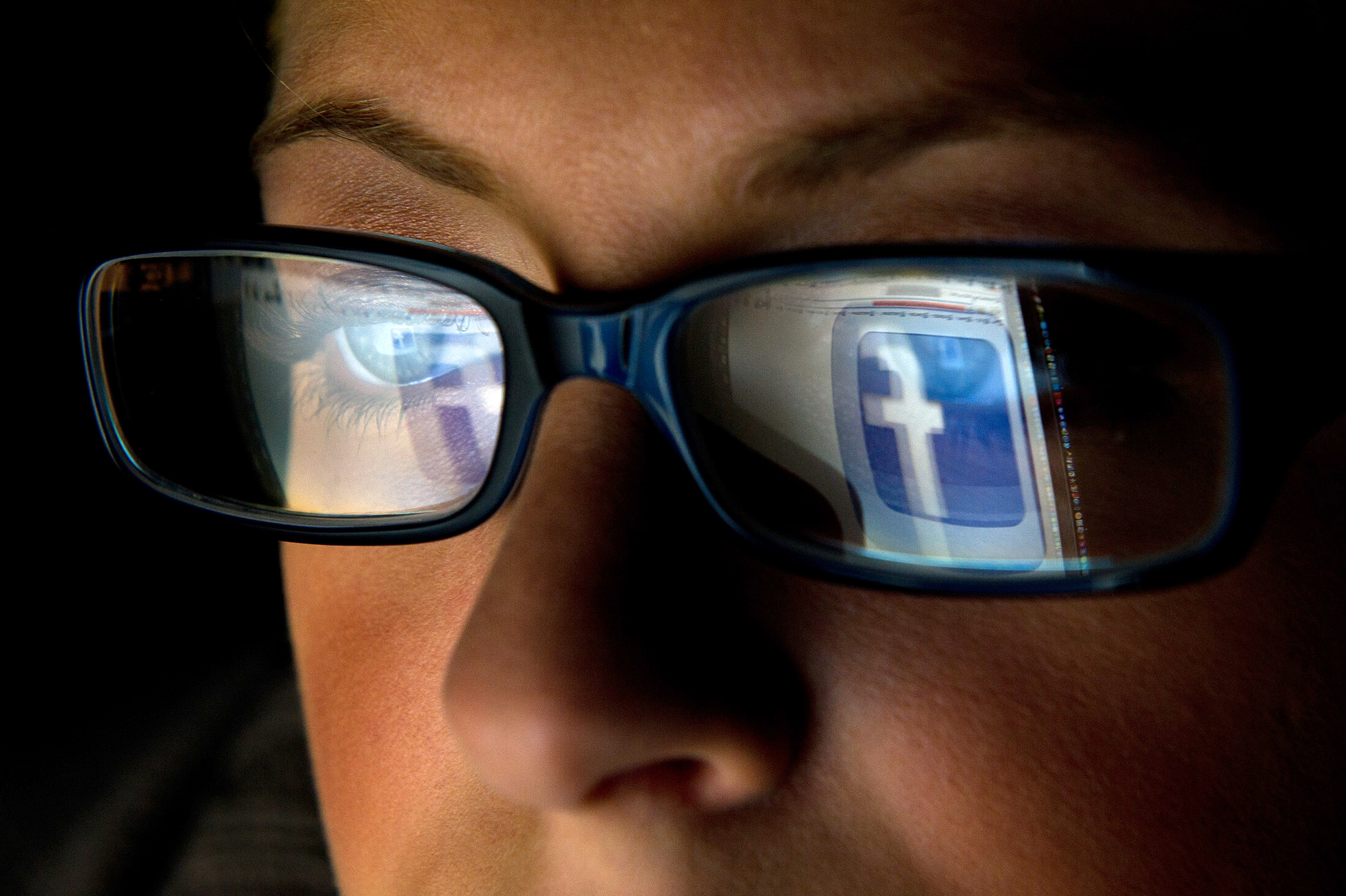 In this file photo the Facebook Inc. logo is reflected in the eyeglasses of a user in this arranged photo in San Francisco, California, U.S., on Wednesday, Dec. 7, 2011. (Bloomberg&mdash;Bloomberg via Getty Images)