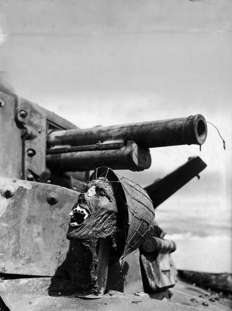 Severed head of a Japanese soldier, propped up on a disabled tank, Guadalcanal, 1942.