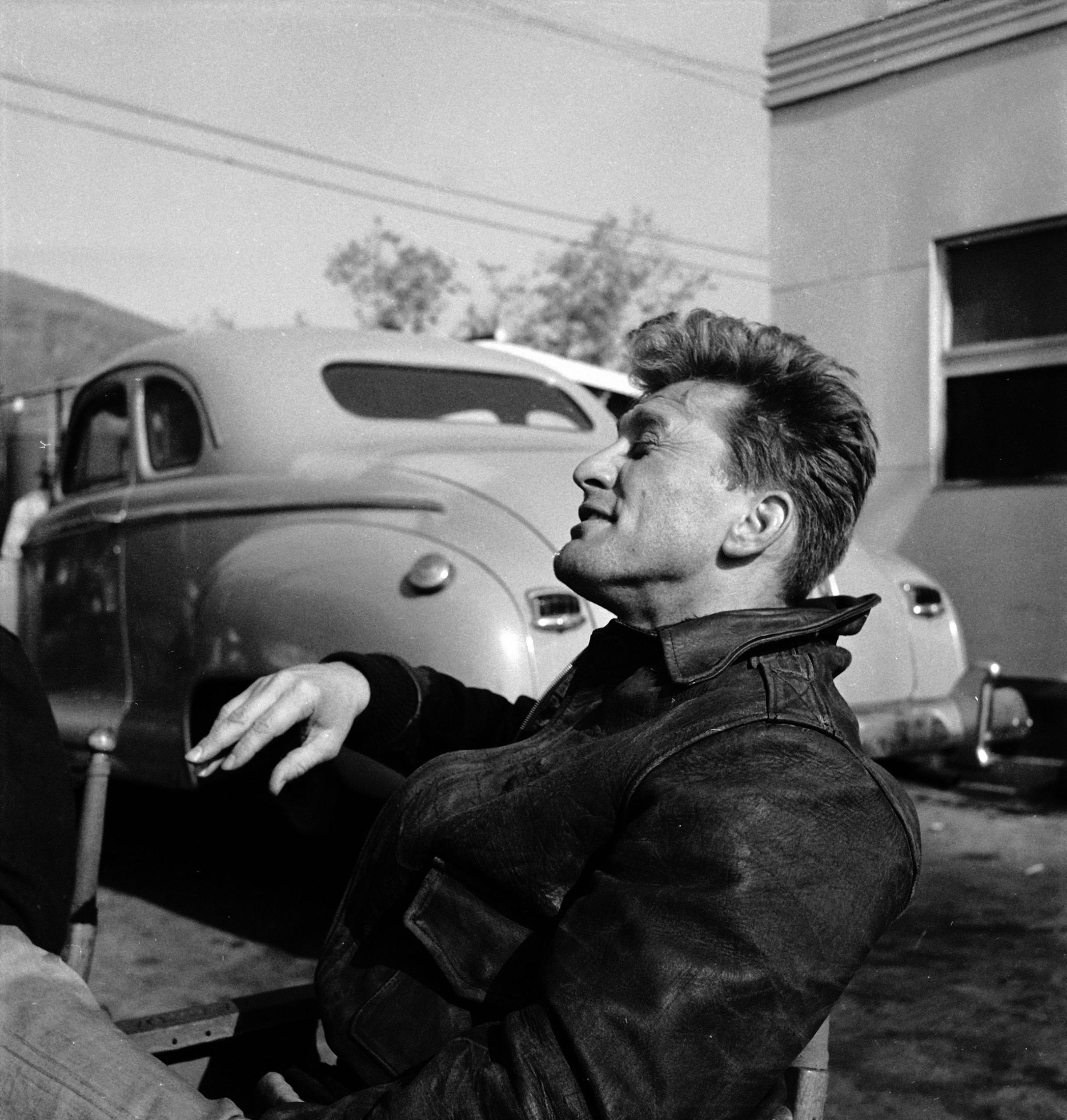 Kirk Douglas relaxing between takes on the set of the 1949 film, "Champion."