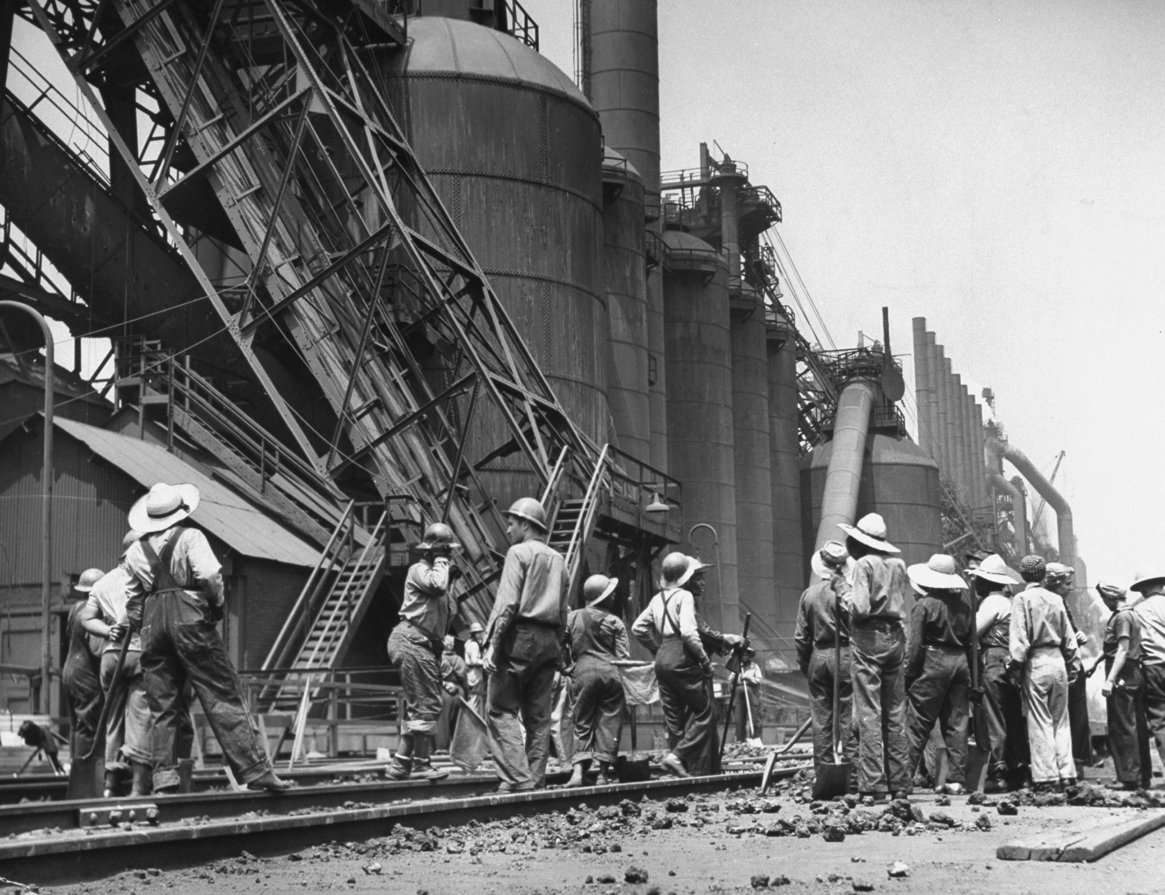Women laborers clear tracks of spilled materials, Gary, Ind. 1943.