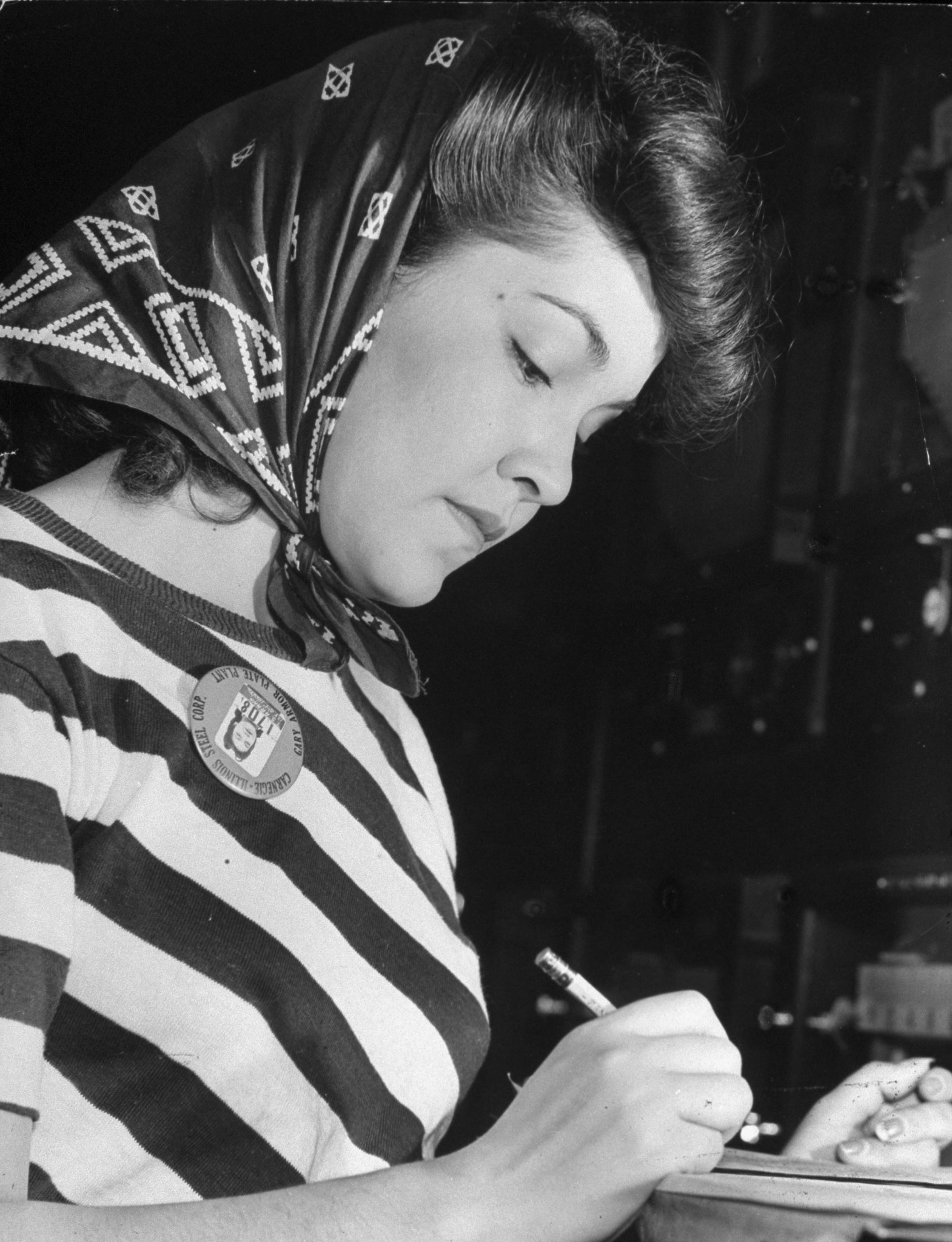 Theresa Arana, 21, takes down temperature recordings at draw furnaces, Gary, Ind., 1943.