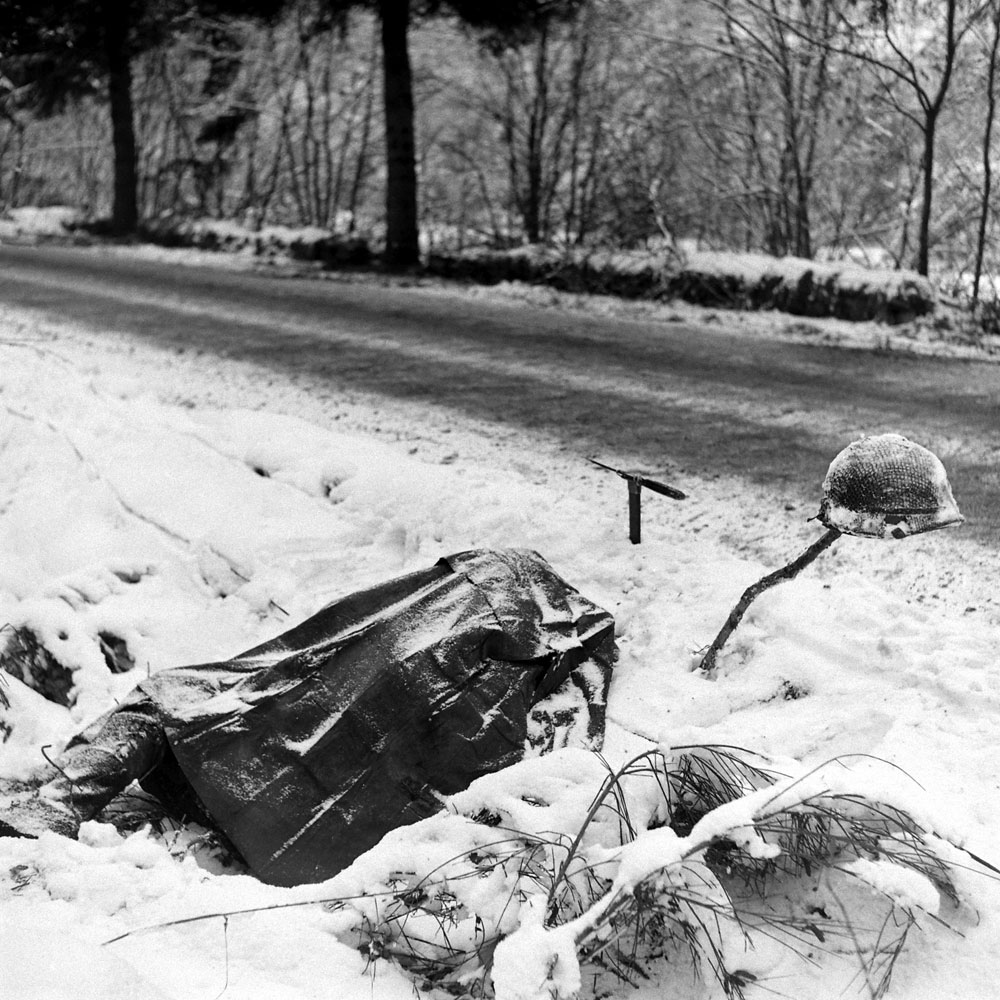 Corpse beside a road during the Battle of the Bulge.