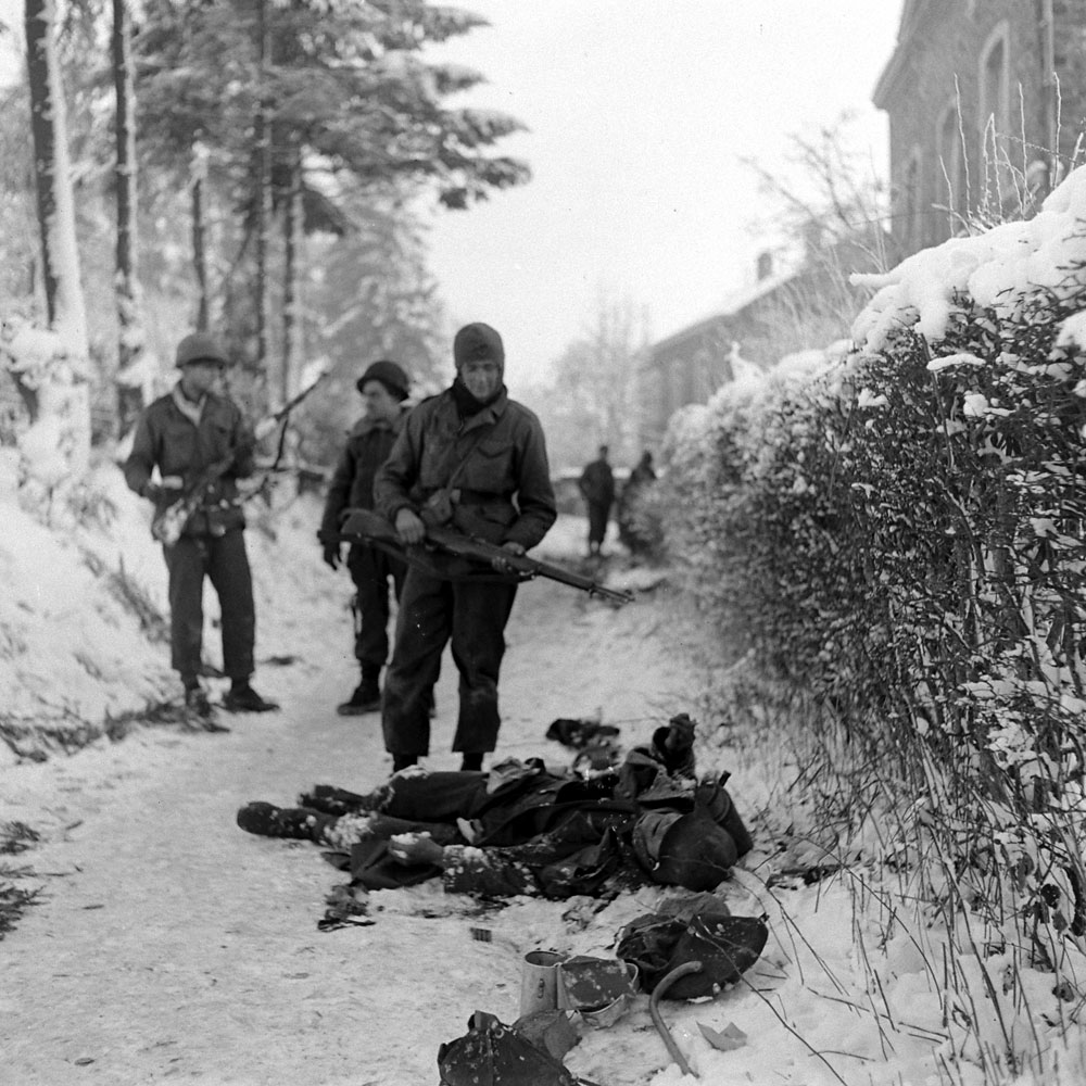 Allied troops and the German dead, Battle of the Bulge.