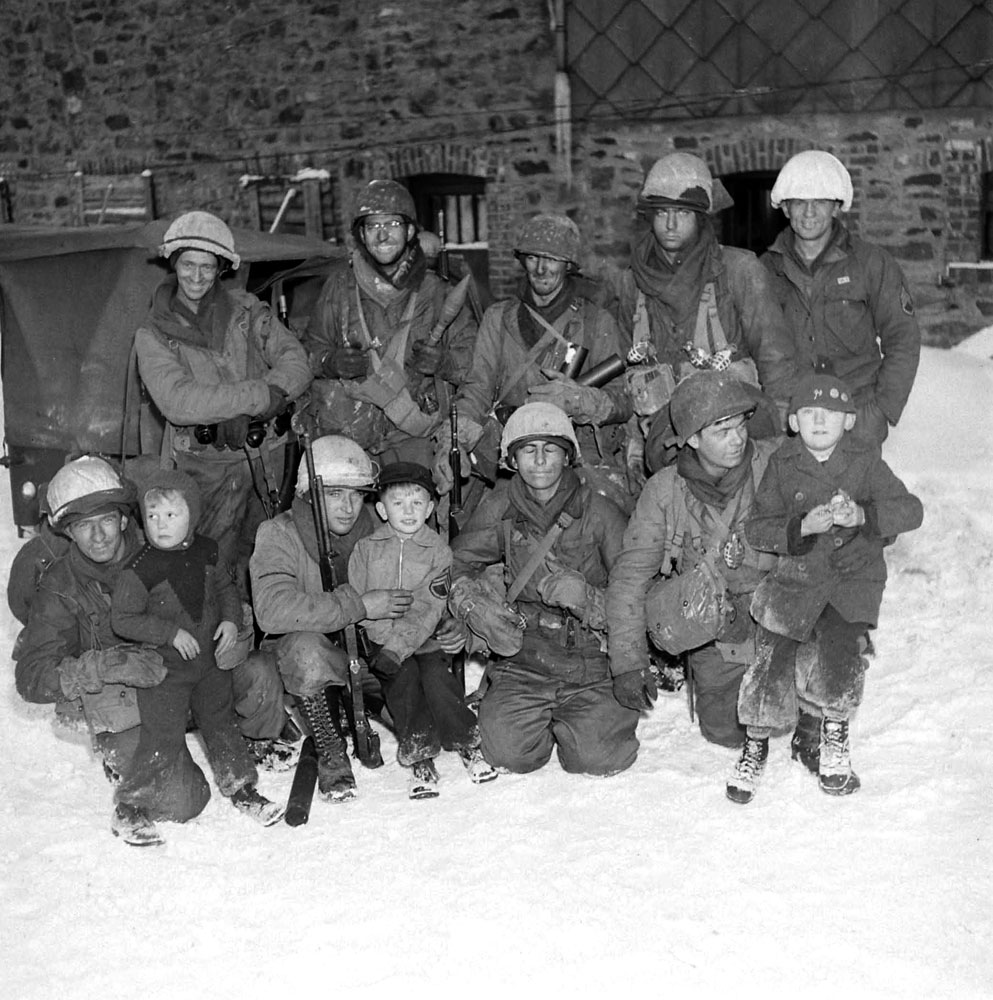 American troops with Belgian children, Battle of the Bulge.