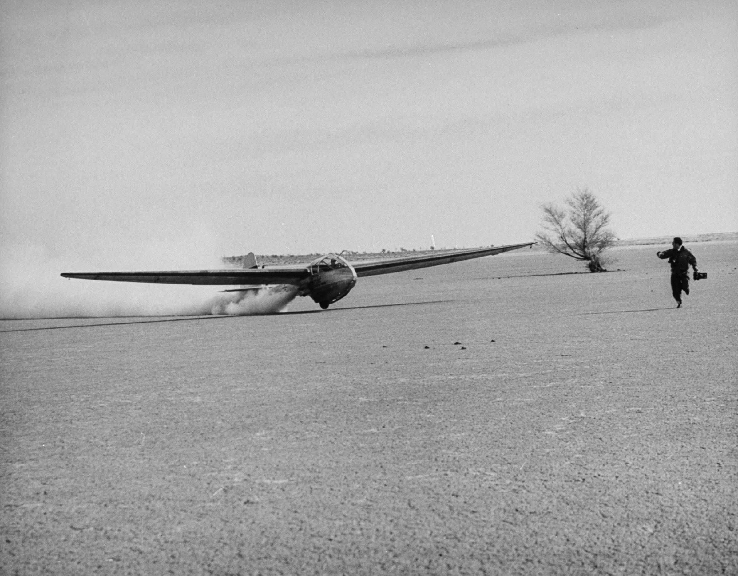 A plane swerves toward LIFE photographer Allan Grant as one rocket motor fails to start, 1949.