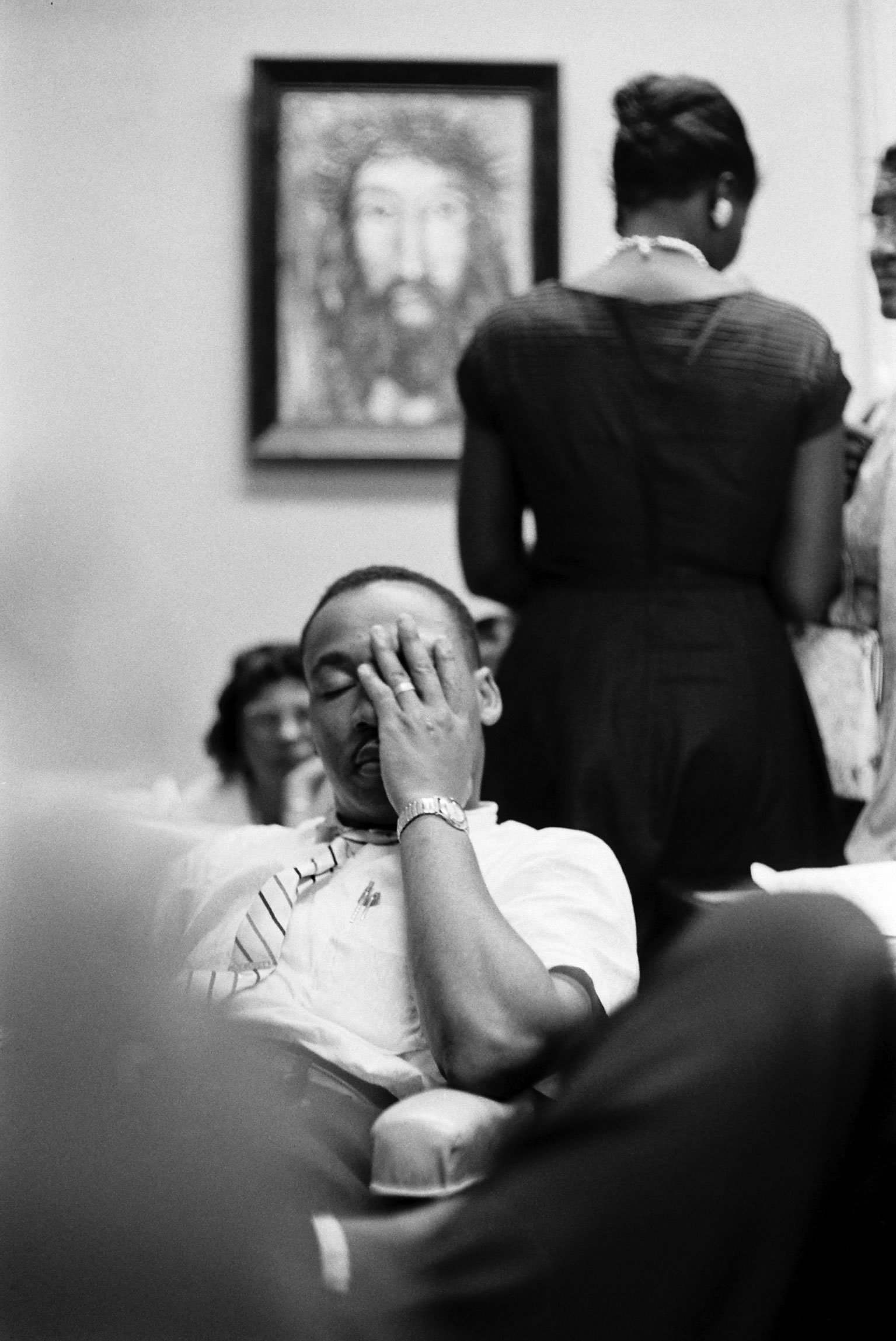 A weary Martin Luther King Jr. sits at the Rev. Ralph Abernathy's First Baptist Church in Montgomery, Ala., as a white mob surrounds the building.