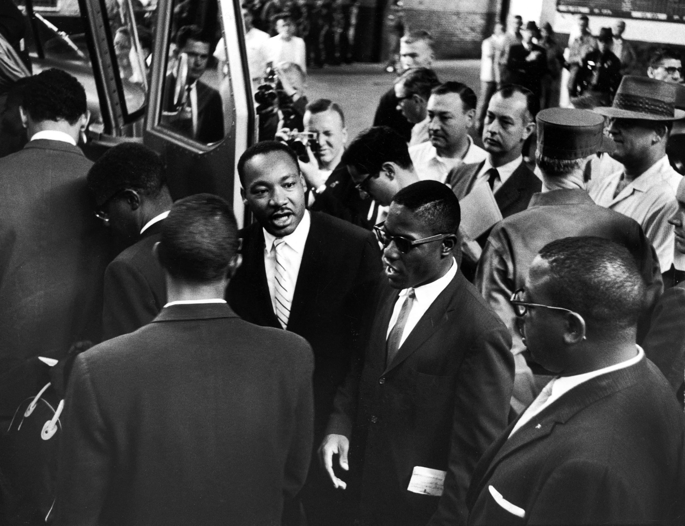 Martin Luther King Jr. encourages freedom riders as they board a bus for Jackson, Miss.