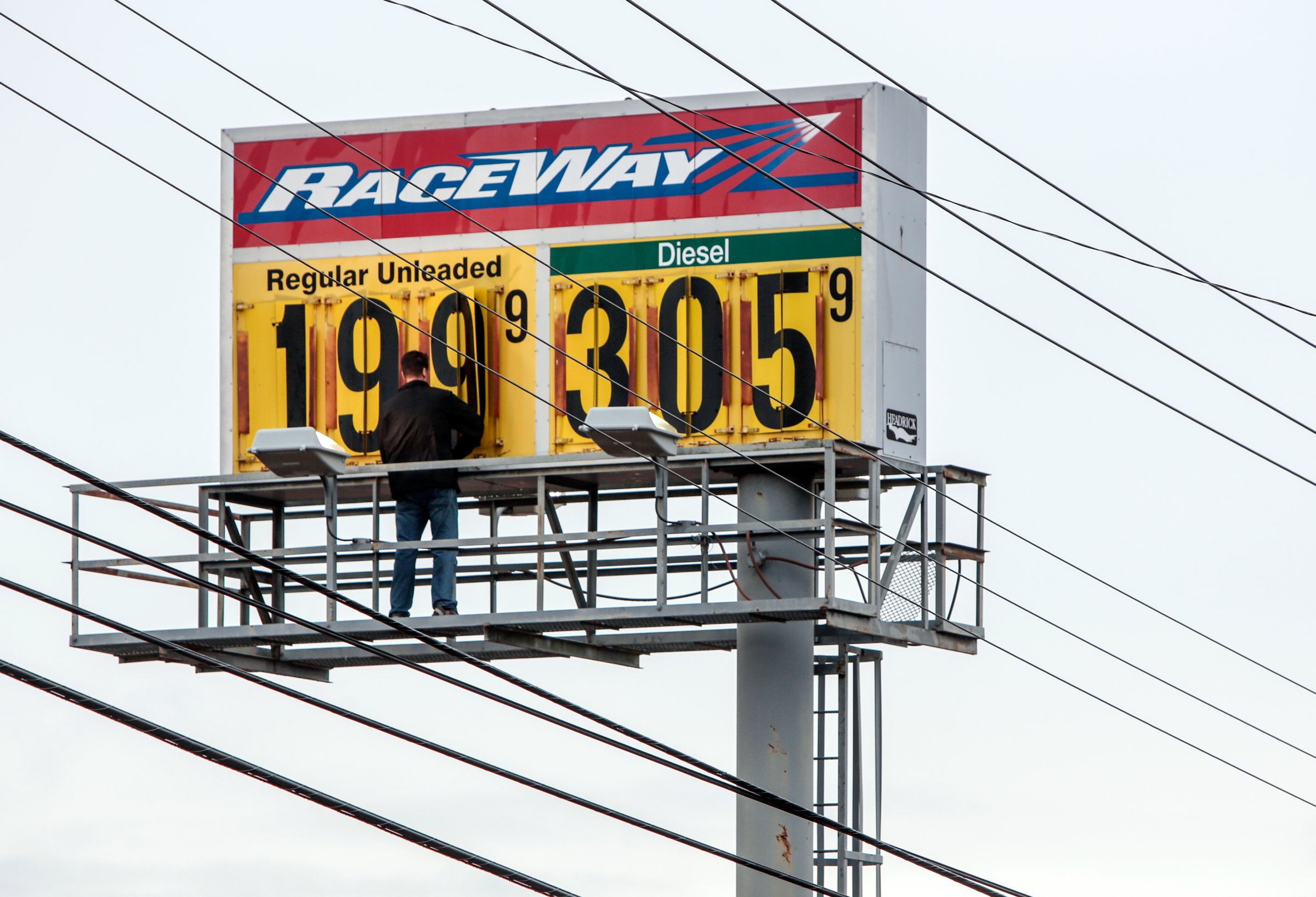 Mark Monaham, owner of the Raceway gas station in McComb, Miss., changes his fuel price billboard, Friday, Dec. 19, 2014. Gas prices throughout the region continue to fall as oil prices plummet.