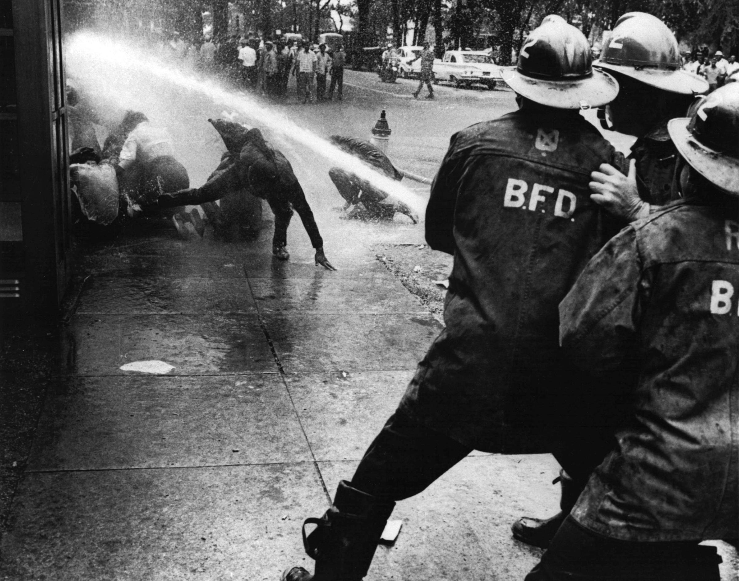 Firefighters turn their hoses full force on civil rights demonstrators in Birmingham, Ala., on July 15, 1963