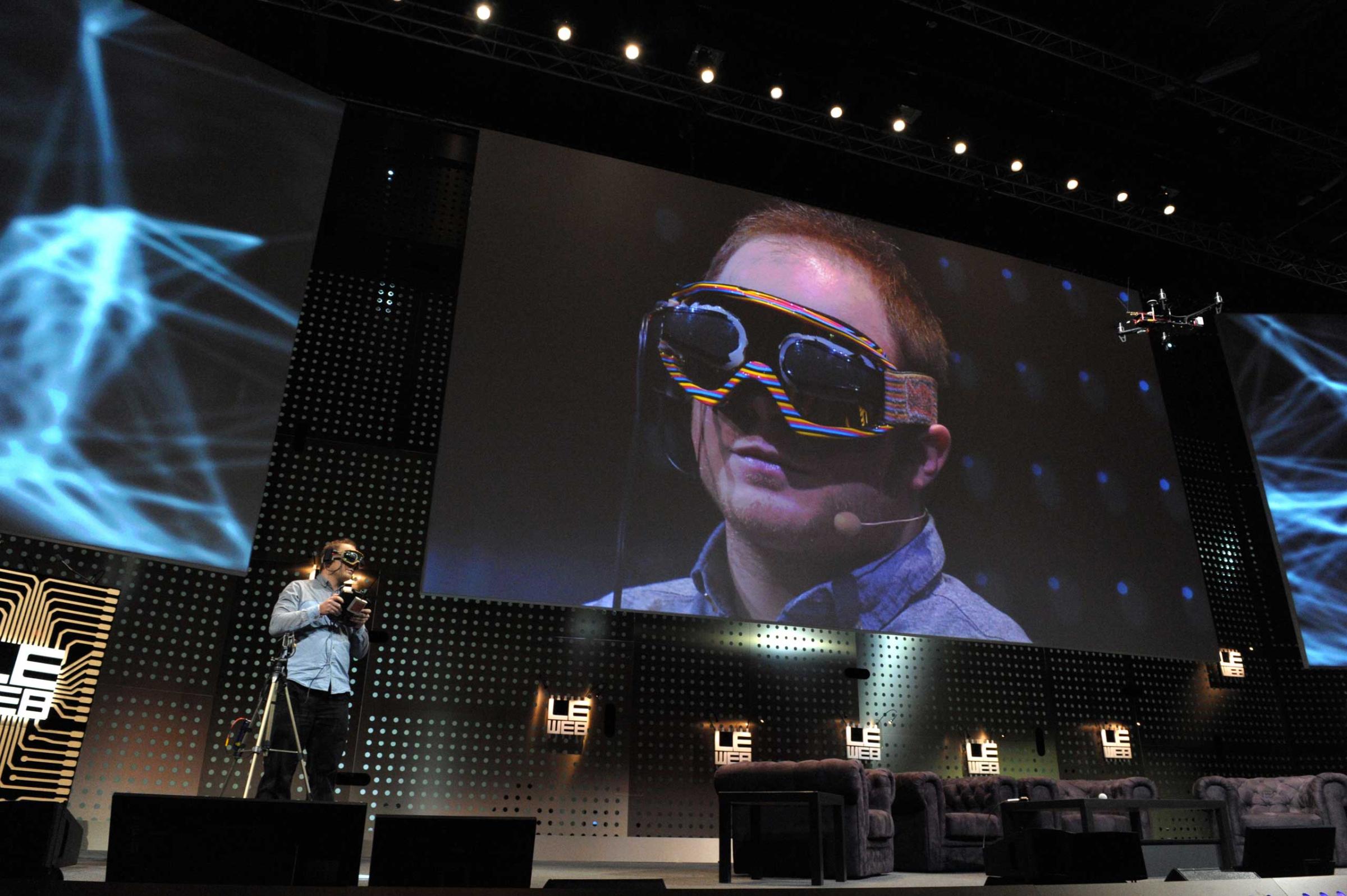 Raphael Pirker from Switzerland, founder of Team BlackSheep used virtual reality goggles to simulate the sensation of flight in the real world during a demonstration, flying from the perspective of a model aircraft, during a session of LeWeb'12 in Saint-Denis, near Paris.