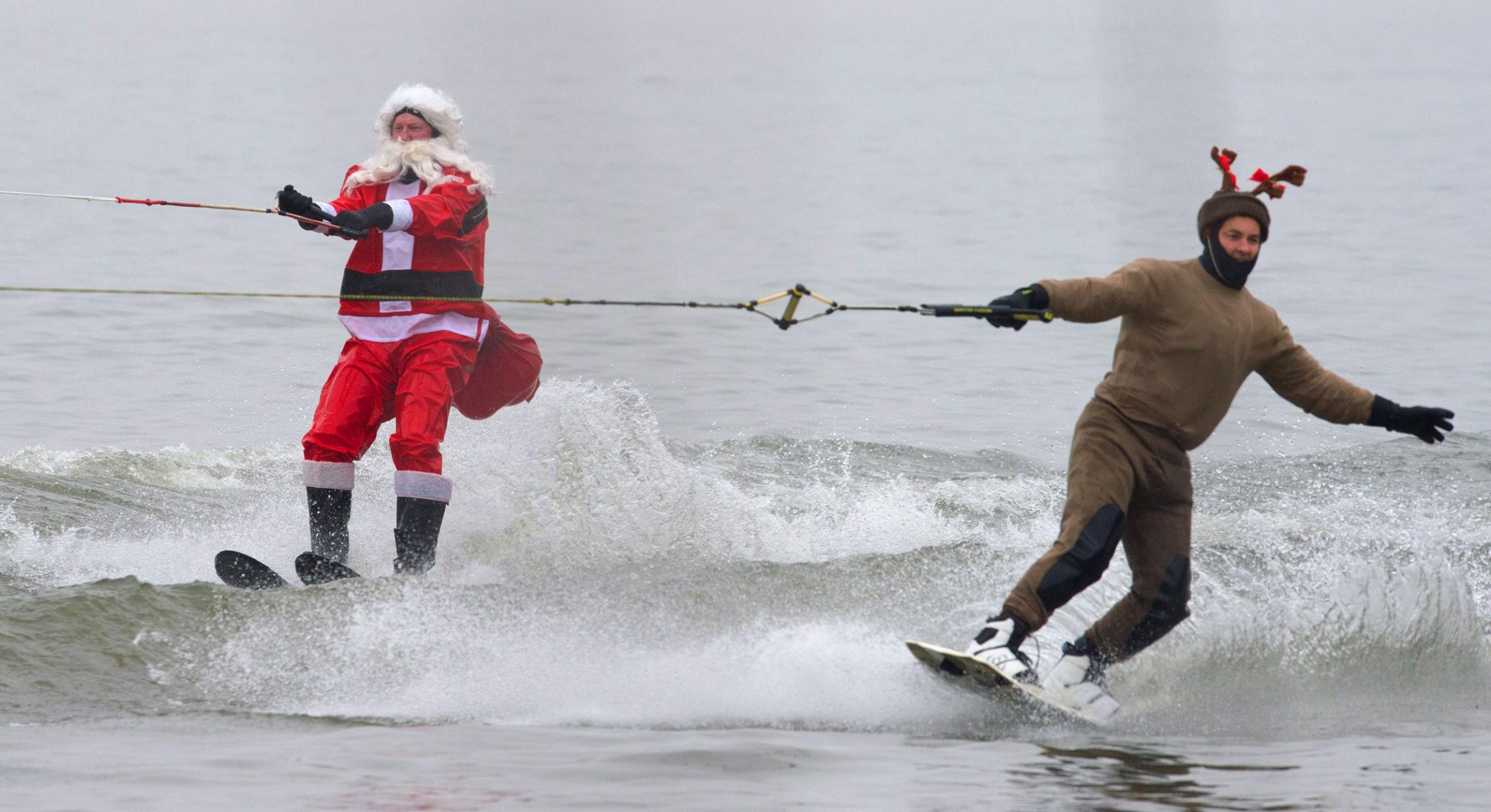 The water-skiing Santa and a Reindeer are seen along the Potomac River off Old Town Alexandria, Virginia, not far from Washington, DC on Dec. 24, 2014 during the annual water-skiing Santa event.