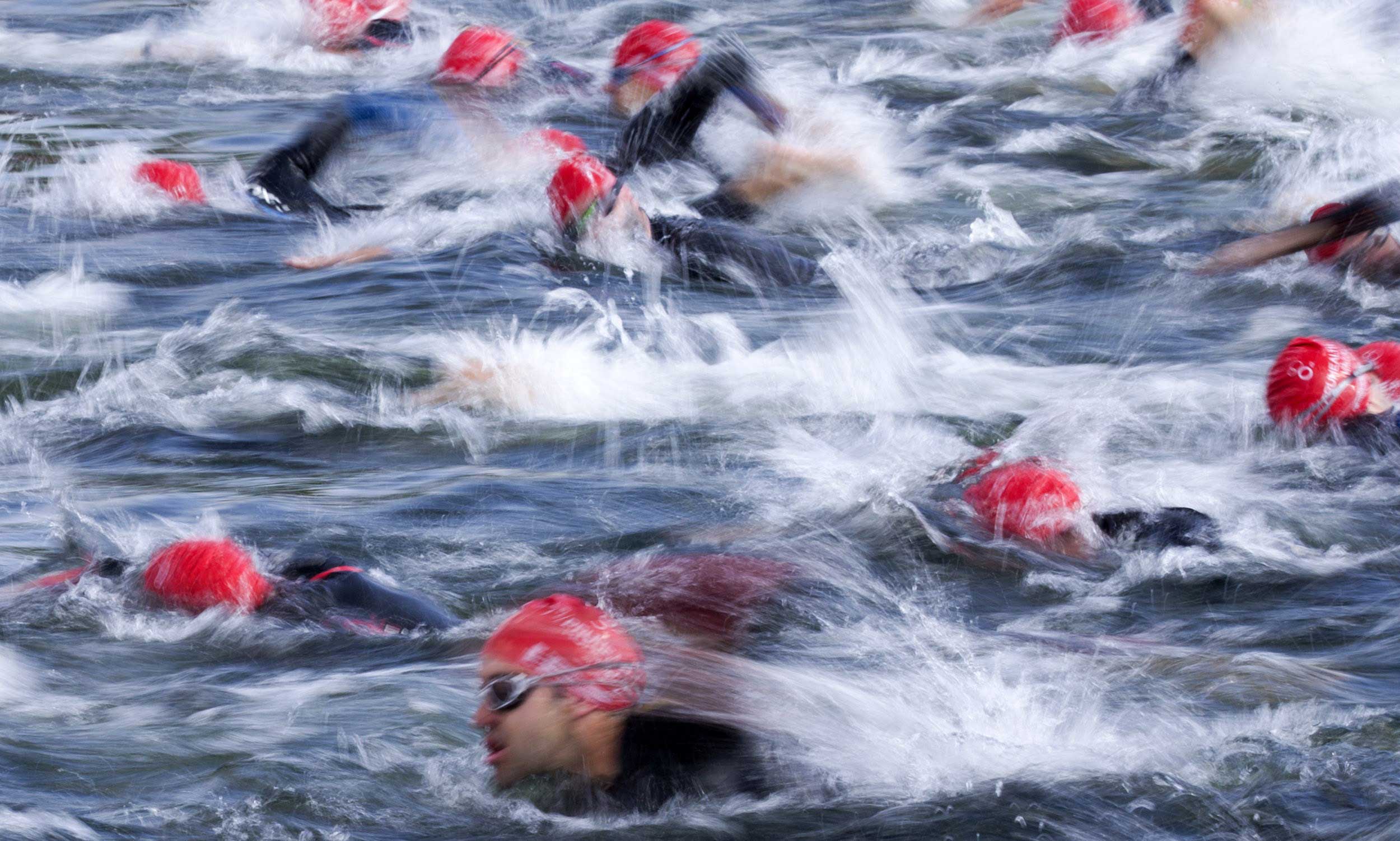 Competitors in the open race over the Olympic distance in the World Triathlon London, the fourth event in the 2014 ITU World Triathlon Series, swim through the Serpentine in Hyde Park, London on June 1, 2014.