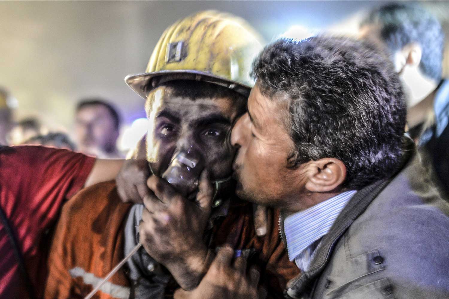 A man kisses his son, rescued of the mine, on May 13, 2014 after an explosion in a coal mine in Manisa. At least 157 miners were killed in collapsed coal mine in the western Turkish city of Manisa.