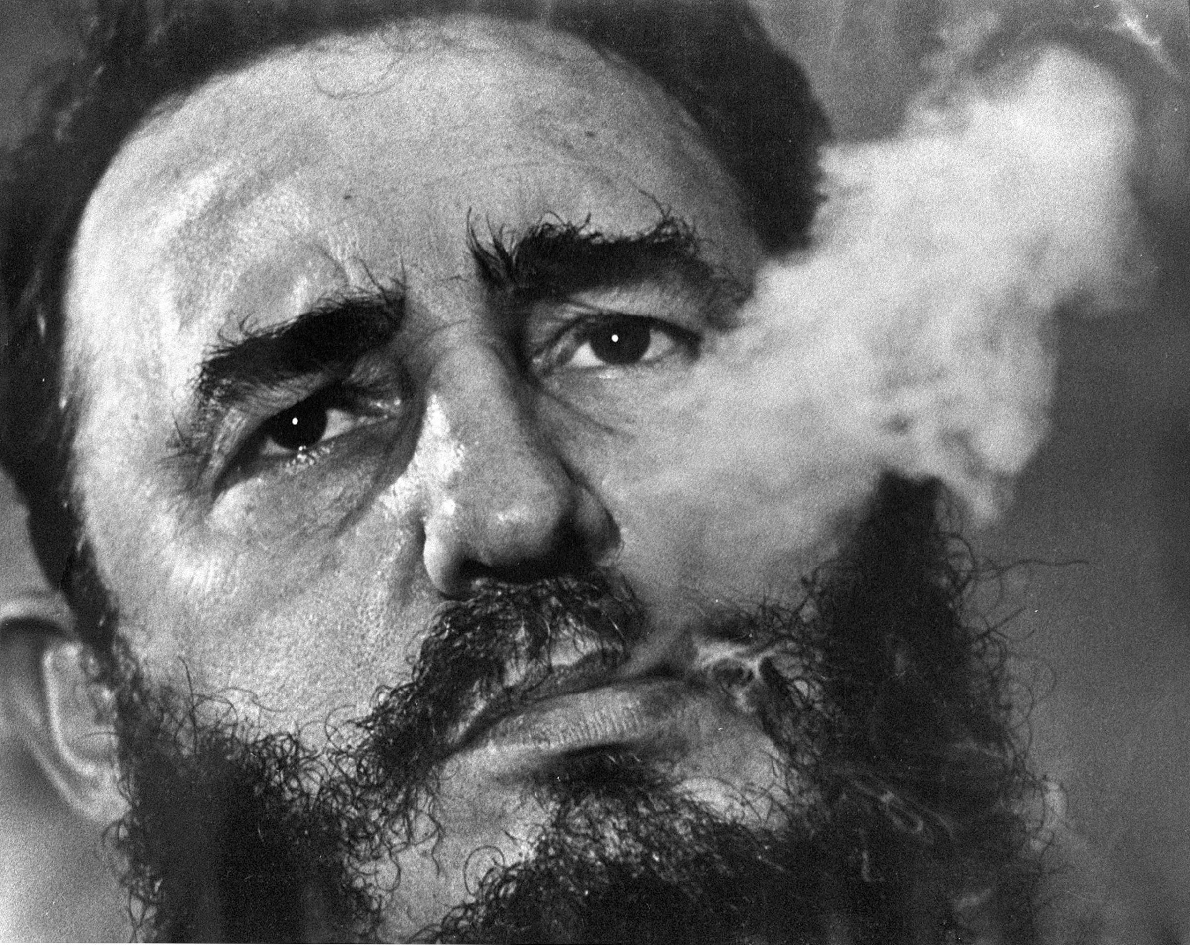 Cuban Prime Minister Fidel Castro exhales cigar smoke during a March 1985 interview at his presidential palace in Havana.
