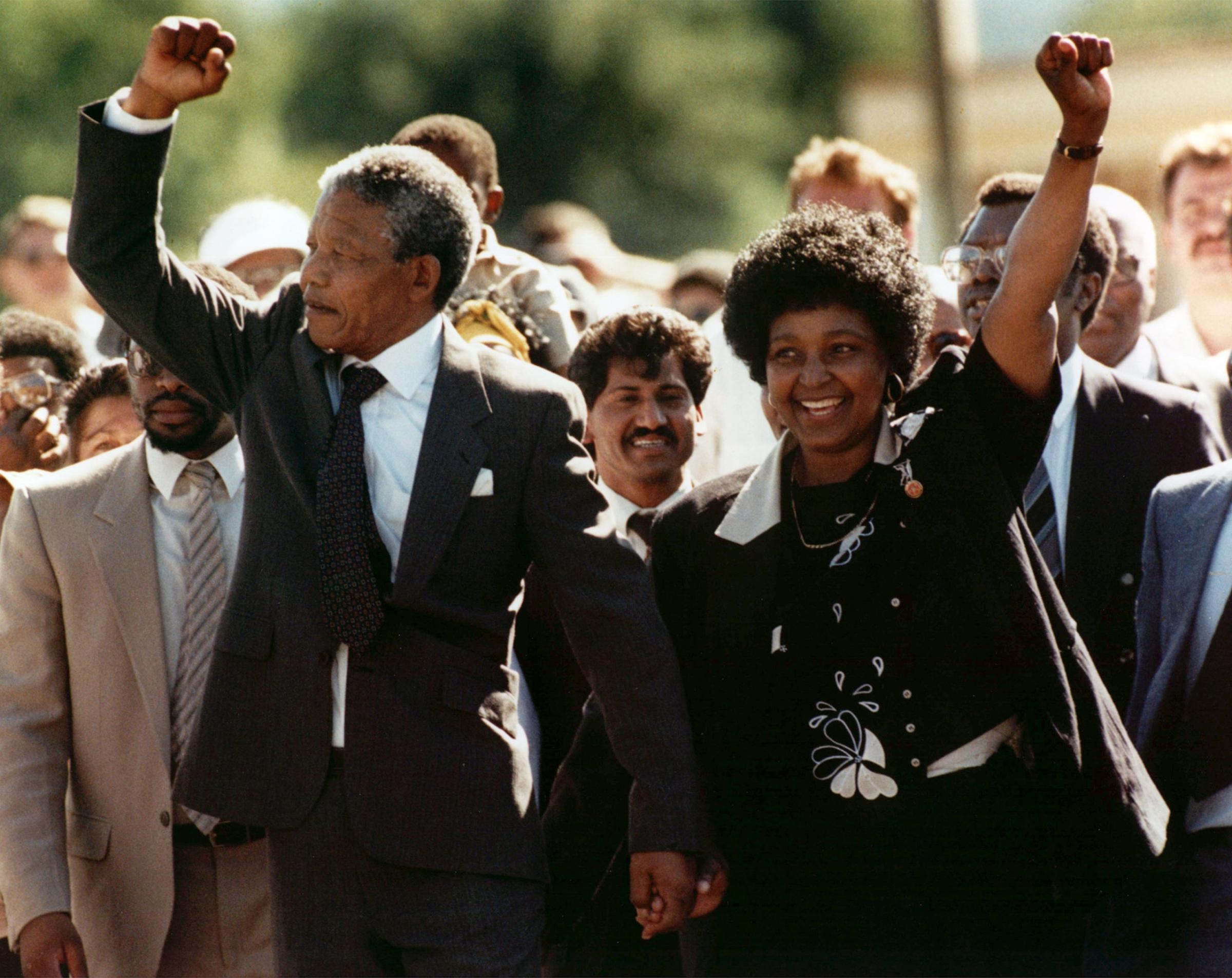 Nelson Mandela and wife Winnie, walking hand in hand, raise clenched fists upon his release from Victor prison in Cape Town on Feb. 11, 1990.