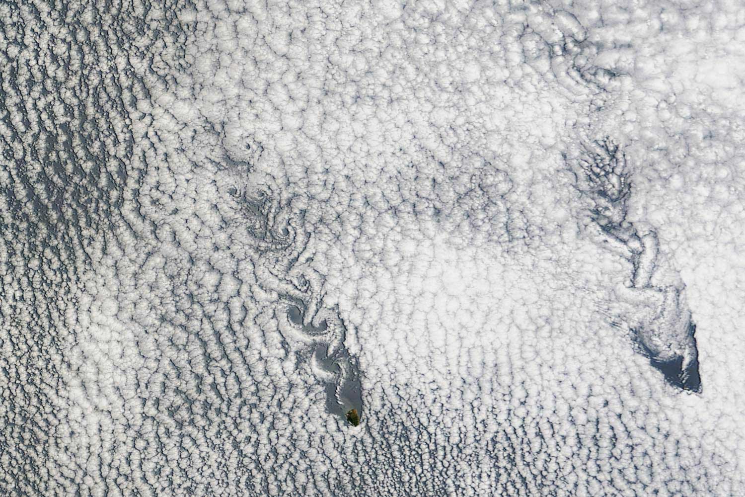 Two small islands had a big impact on the skies over the Pacific Ocean, disrupting clouds in a way that created a paisley pattern 175 miles long.