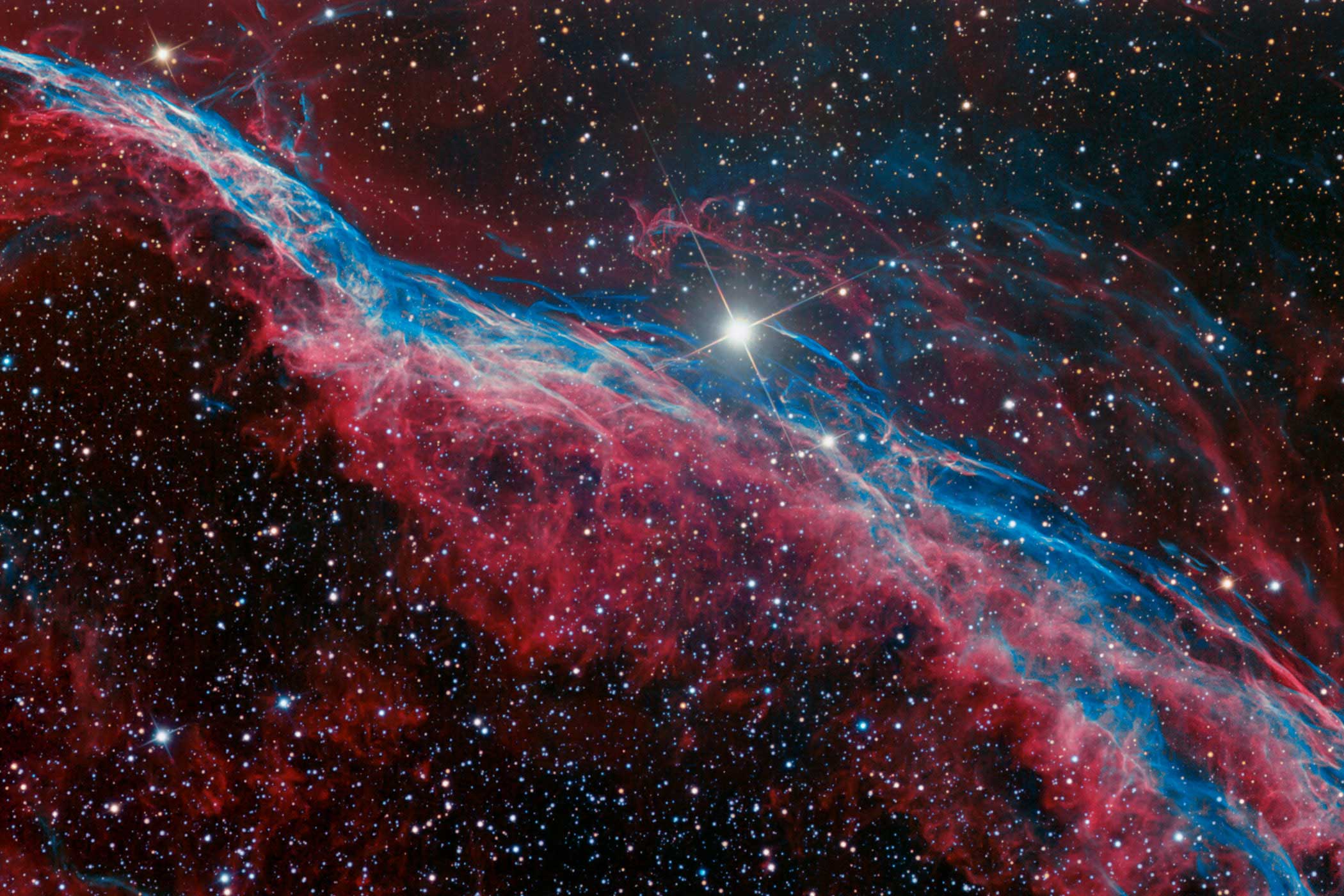 Part of the Veil Nebula, the Witch's Broom is the glowing debris from a supernova explosion. It's what's left over after the violent death of a massive star. Although the supernova occurred several thousand years ago, the gaseous debris is still expanding outwards, producing this vast cloud-like structure.