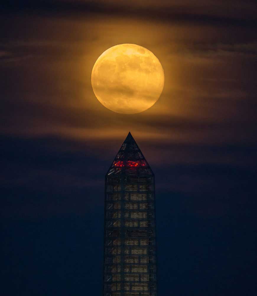 A supermoon rises behind the Washington Monument, on June 23, 2013, in Washington, D.C. This year the Supermoon was up to 13.5% larger and 30% brighter than a typical Full Moon is. This is a result of the Moon reaching its perigee—the closest that it gets to the Earth during the course of its orbit.
