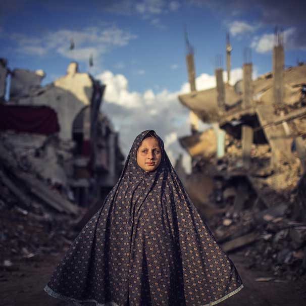 A #Palestinian #girl stands during a #rain storm while #walking through a neighbourhood #destroyed during the 50 day conflict between #Israel and #Hamas, in the Shejaiya neighbourhood of #Gaza #City on October 20, 2014. By Wissam Nassar @wissamgaza #wissamgaza #war #NYT