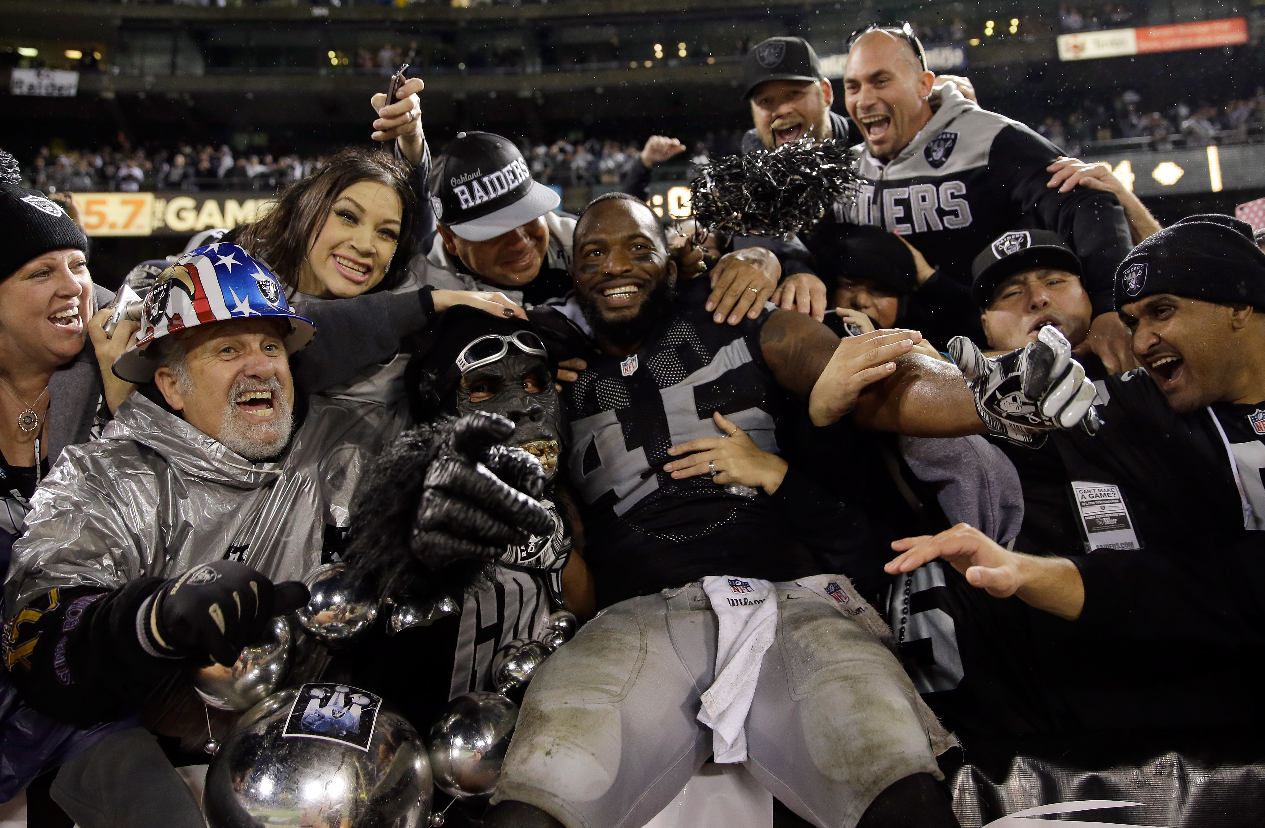 Marcel Reece #45 of the Oakland Raiders celebrates with fans in the Black Hole after the Raiders beat the Kansas City Chiefs at O.co Coliseum on November 20, 2014 in Oakland, California. (Ezra Shaw&mdash;Getty Images)