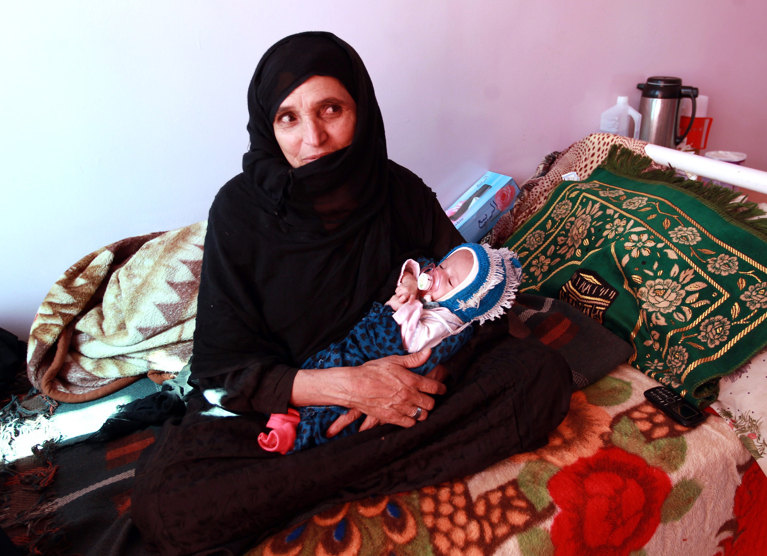 A Yemeni mother holds her malnourished infant at a therapeutic feeding centre in the capital Sanaa on December 9, 2014. Over one million Yemeni girls and boys under 5 suffer from acute malnutrition, including 279,000 who suffer from severe acute malnutrition (SAM), in a situation exacerbated by political instability, multiple localized conflicts and chronic underdevelopment, according to UNICEF. (MOHAMMED HUWAIS&mdash;AFP/Getty Images)