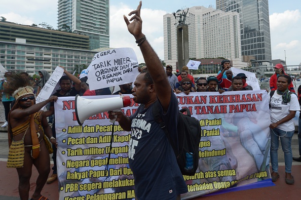 A Papuan activist delivers speech at the Hotel Indonesia roundabout in Jakarta on Dec. 10, 2014, during a protest against the killings of teenagers in the Papuan town of Enarotali two days earlier (Adek Berry—AFP/Getty Images)