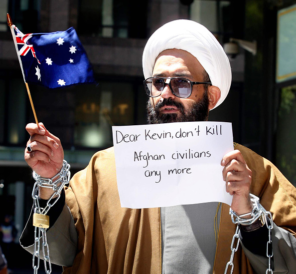 November 10, 2009: Sydney, NSW. Iranian born Muslim cleric, Sheik Haron, who is named in court papers as Man Haron Monis, chained to a railing outside the Downing Centre Court in Sydney in an anti-war protest. He had appeared in court to face charges of sending offensive letters to families of Australian soldiers who died in Afghanistan. Keywords: court case / criminal charges / islam / muslim faith / offensive material / demonstration / australian flags / signs (Photo by Cameron Richardson / Newspix)Contact Email: www.newspix.com.auContact Web URL: newspix@newsltd.com.auContact Email: www.newspix.com.au