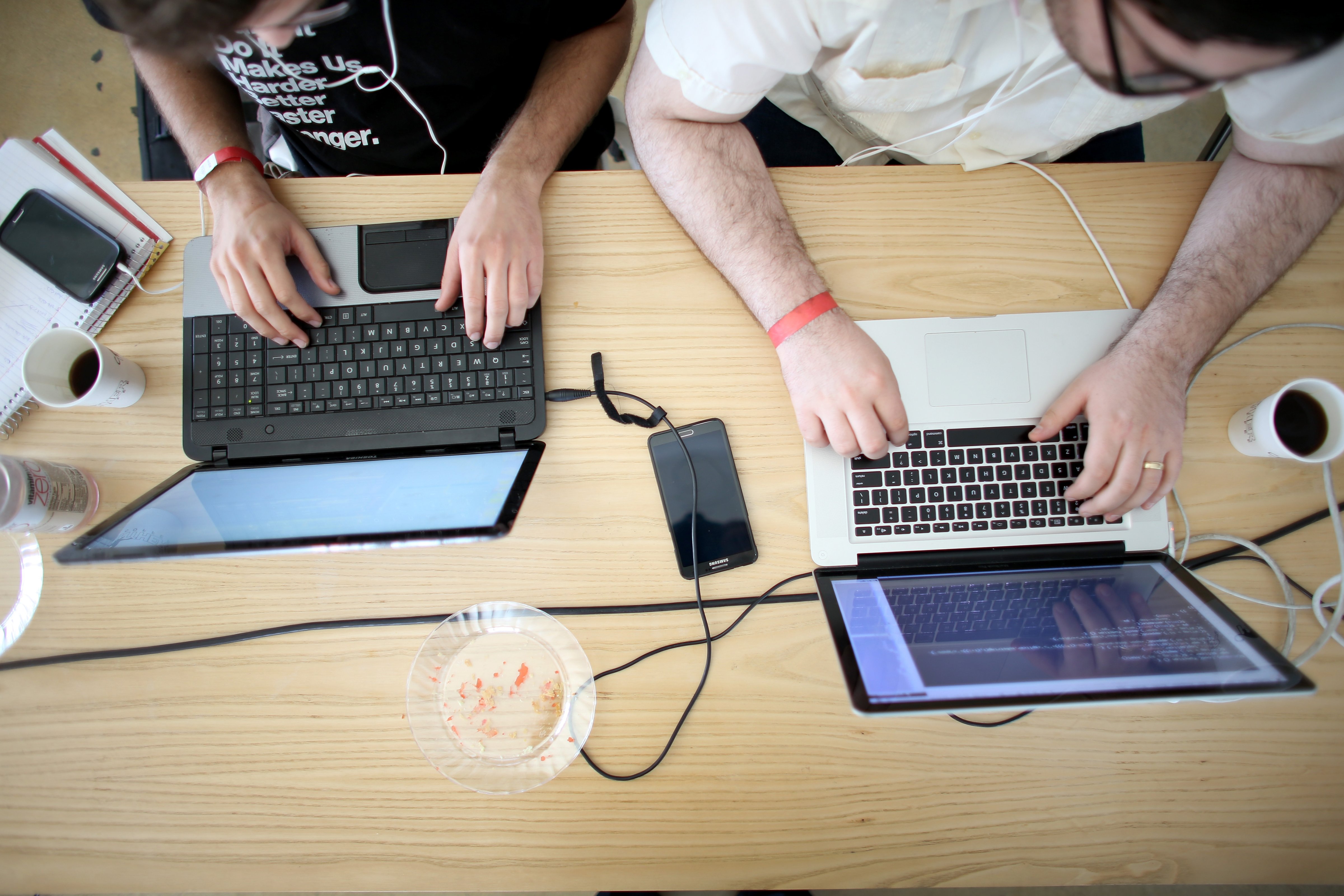Miguel Chateloin  (L) and Lazaro Gamio (R) use their computers to write code that would allow people living in Cuba to use email to post to blogs during the Hackathon for Cuba event on Febr. 1, 2014 in Miami. (Joe Raedle—Getty Images)