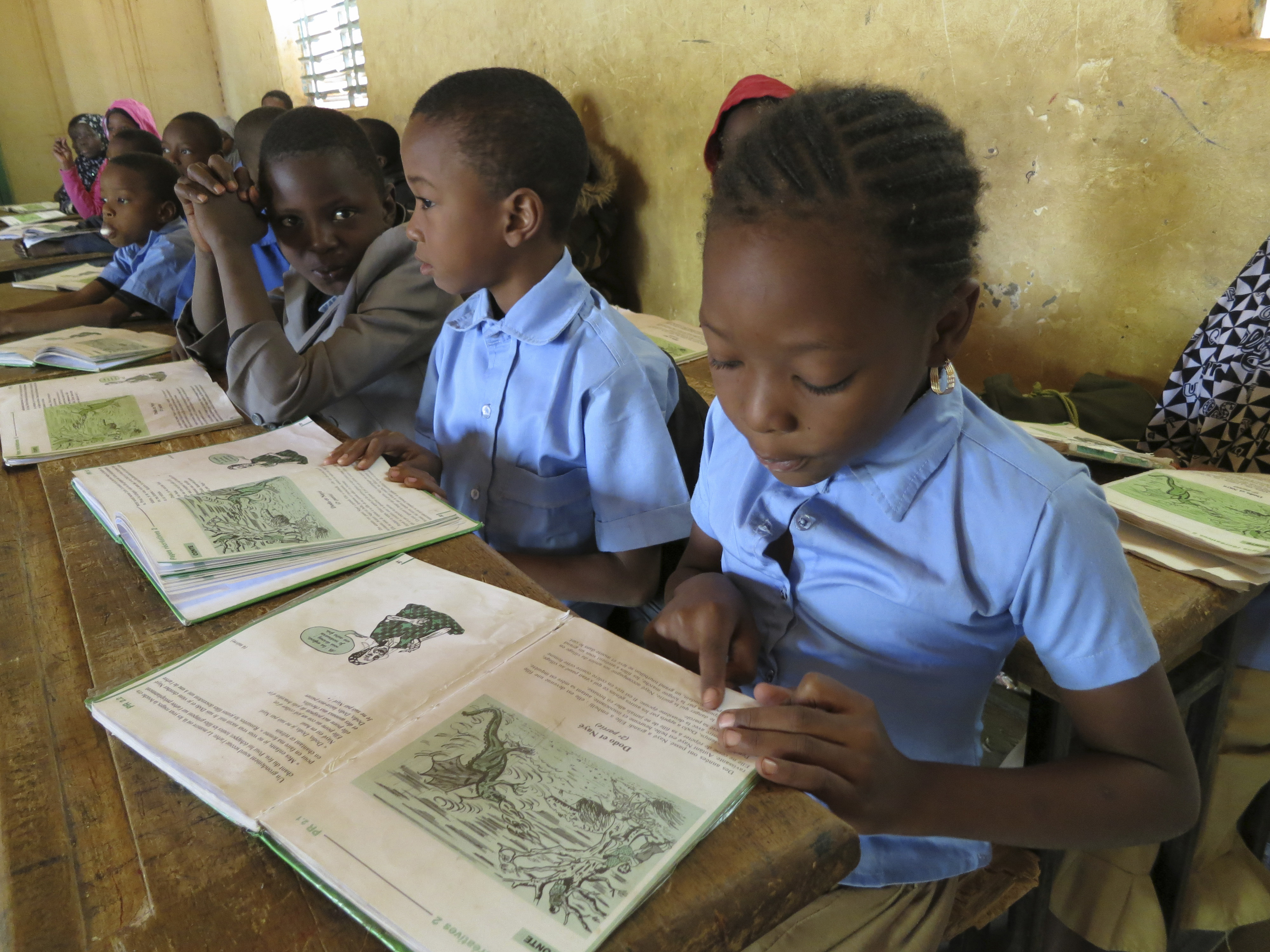 Students reading in school books at a Nigerian school on December 09, 2013, in Niamey, Niger. (Ute Grabowsky—Photothek via Getty Images)