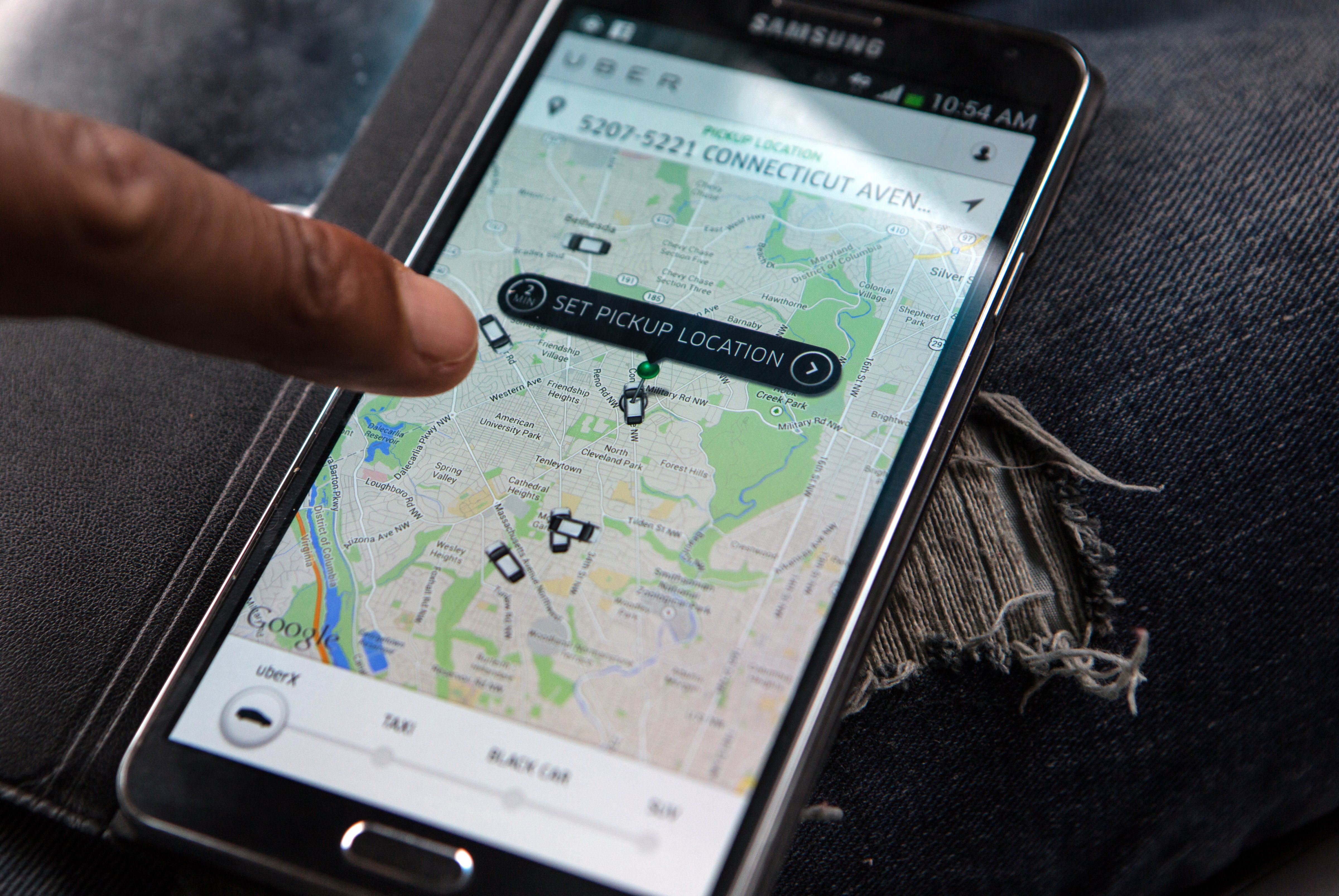 UberX driver, Michael Belet, checks the Uber customer app to see where other Uber drivers are working so he can determine where the best place for him to get fares might be, April 7, 2014, in Washington, D.C. (The Washington Post/Getty Images)