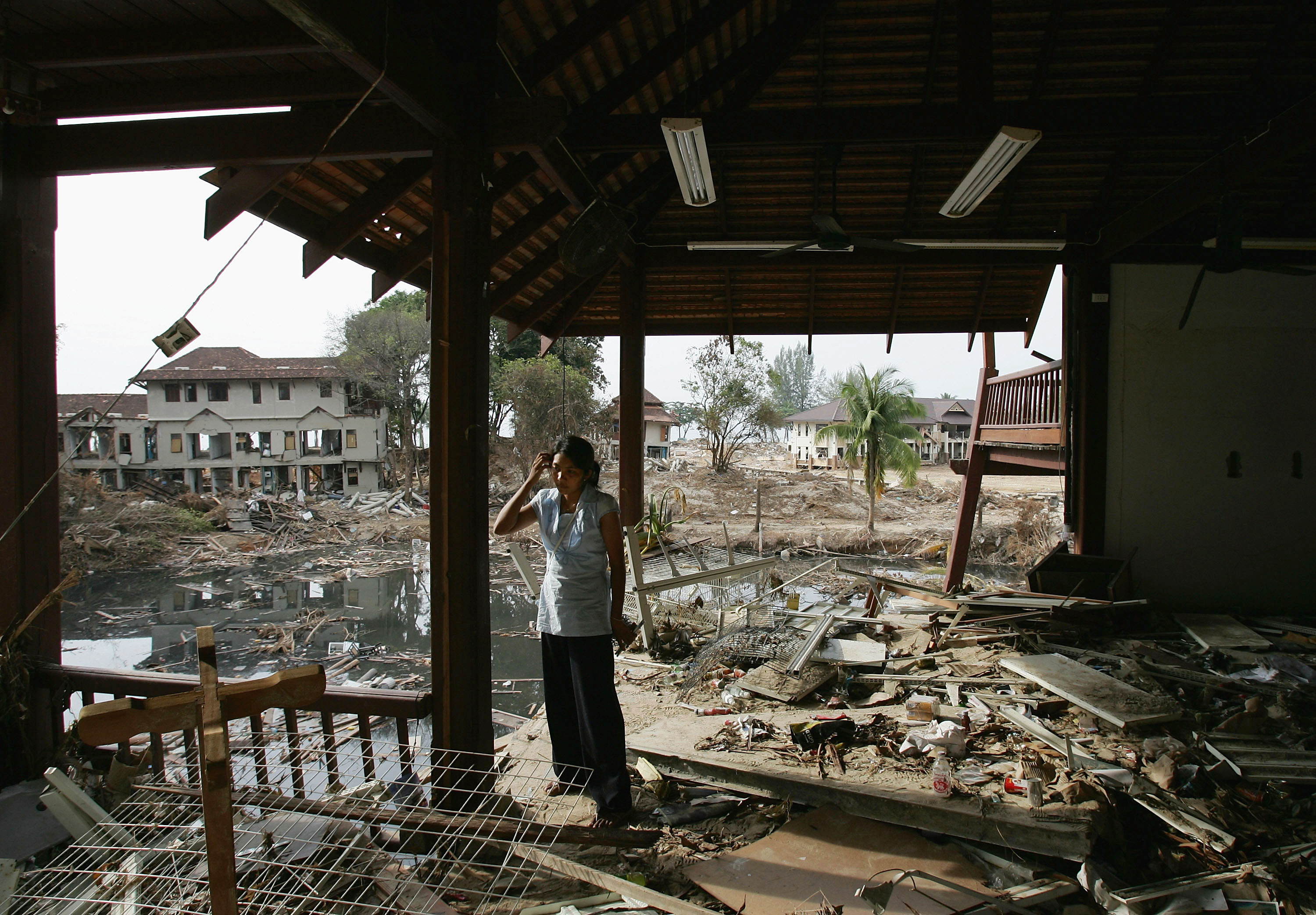 Tsunami survivor Paphun Somsri of Thailand returns to the destroyed seaside hotel where she used to work, in Khao Lak, Thailand on Jan. 7, 2005 (Andrew Wong—Getty Images)