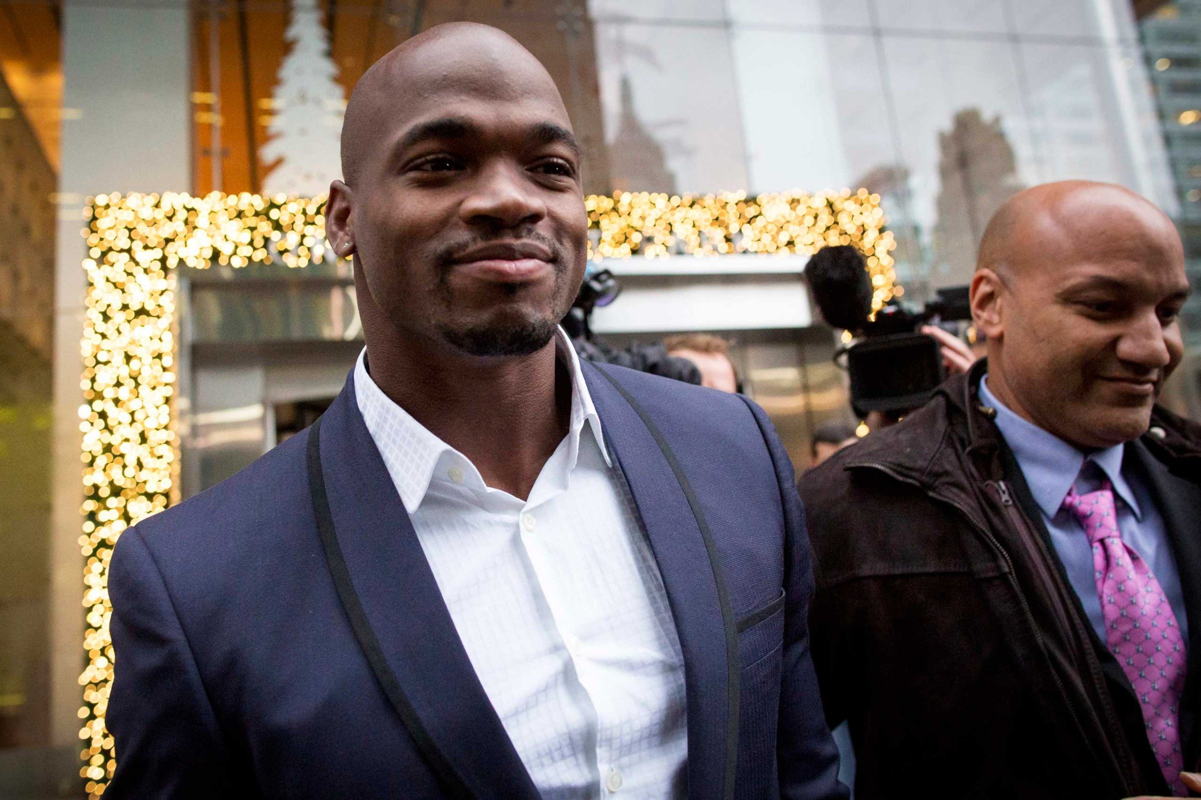 Suspended Minnesota Vikings running back Peterson exits following his hearing against the NFL over his punishment for child abuse, in New York