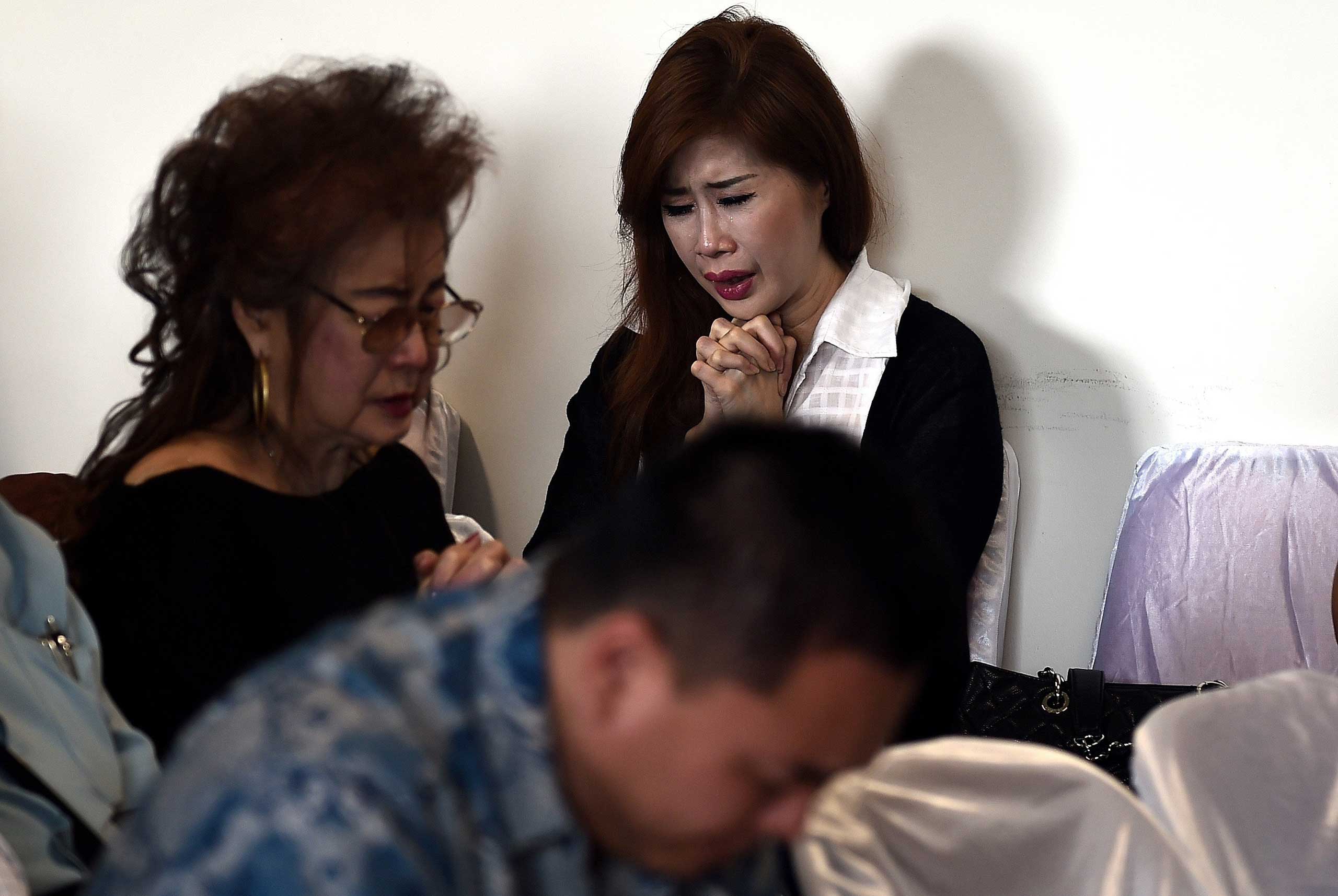 Family members of passengers onboard the missing AirAsia flight QZ8501 attend a briefing inside the crisis-centre at Juanda International Airport in Surabaya, Indonesia on Dec. 29, 2014.