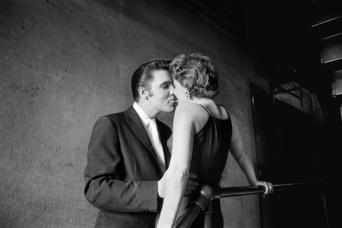 Backstage at the Mosque Theatre where he was scheduled to perform two shows, Elvis Presley kisses Bobbi Owens in Richmond, Va., on June 30, 1956.