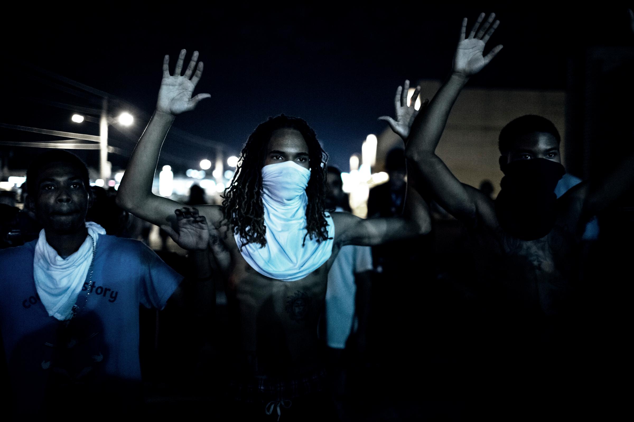 Demonstraters during clashes with police that erupted folwoing a mostly peacful protest at 12:30 AM on Wednesday, Aug 20, 2014 in Furguson, MO.Photograph by ANDREW CUTRAROÑREDUX FOR TIMEIssue Date: September 1, 2014 / U.S. Edition / Volume 184 / Number 8*FINAL *LOW RESFROM SHOOT* RETOUCHED FILE* Please contact photographer for usage