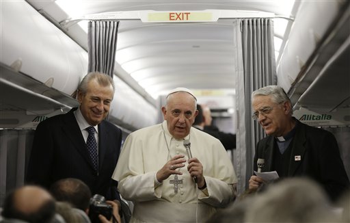 Pope Francis, center, talks during a press conference aboard the flight toward Rome on Nov. 30, 2014 (Gregorio Borgia—AP)