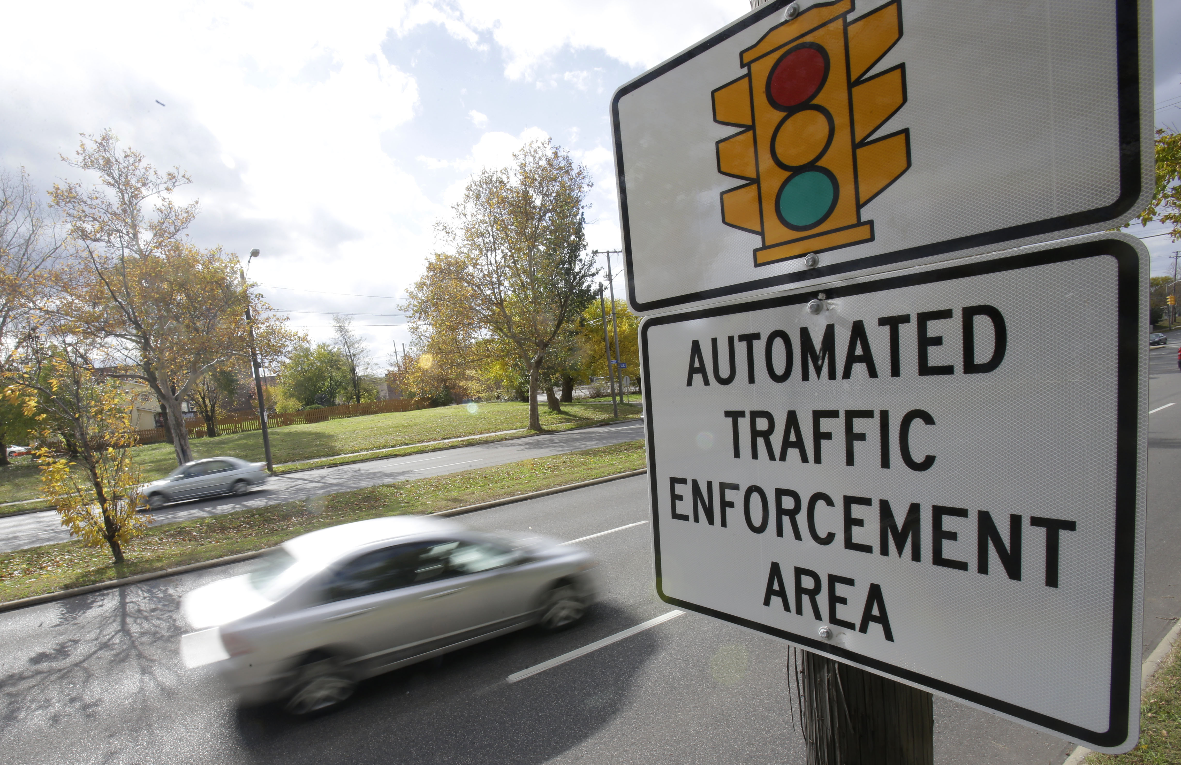 Motorists drive past a sign warning of upcoming traffic cameras on Oct. 29, 2014, in Cleveland, Ohio. (Tony Dejak—AP)