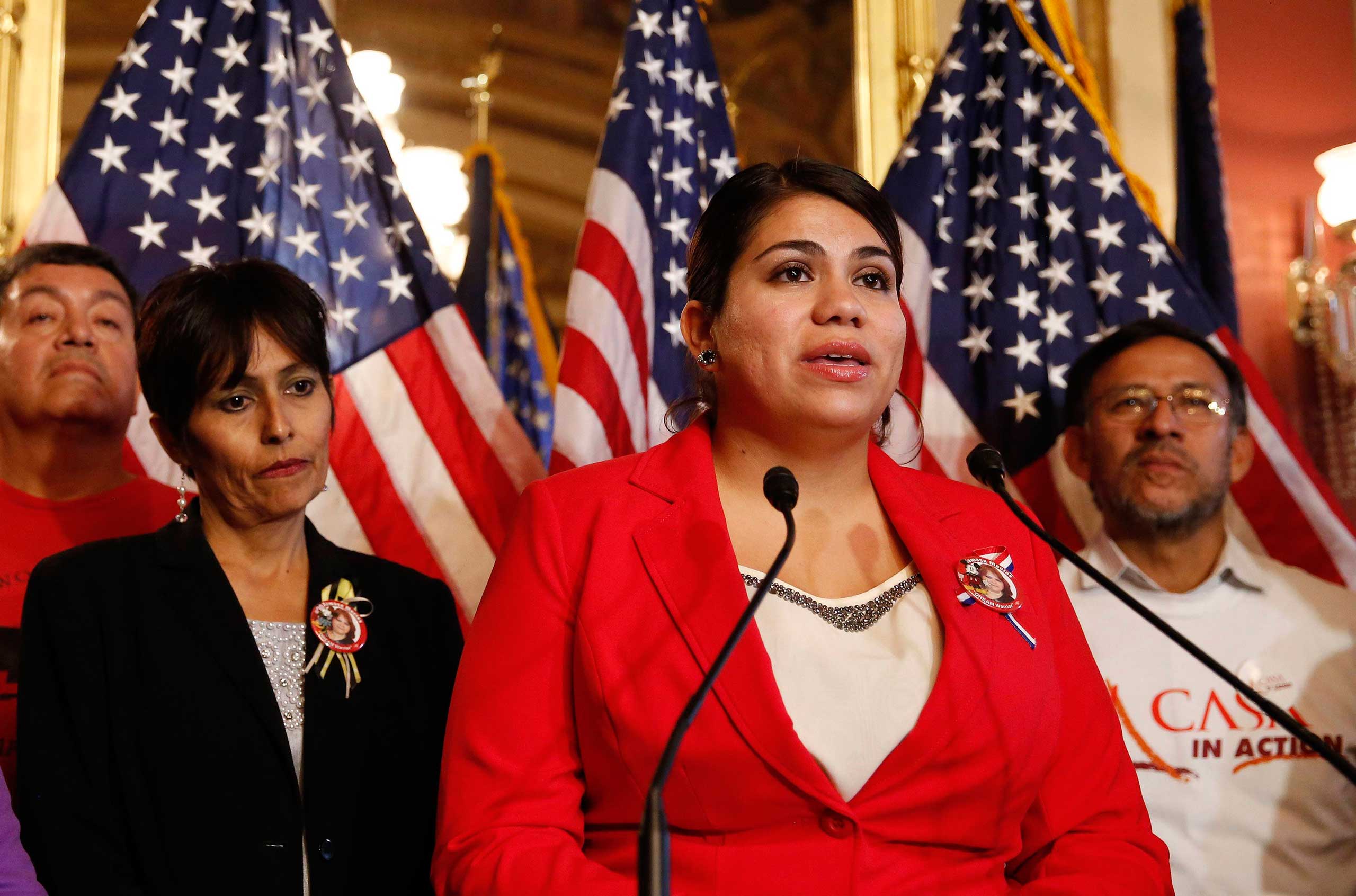 Immigration activist Astrid Silva (in red) stands next to her mother, Barbara Silva, as she speaks about immigration reform at a news conference on Capitol Hill in Washington, Dec. 10, 2014. (Larry Downing—Reuters)