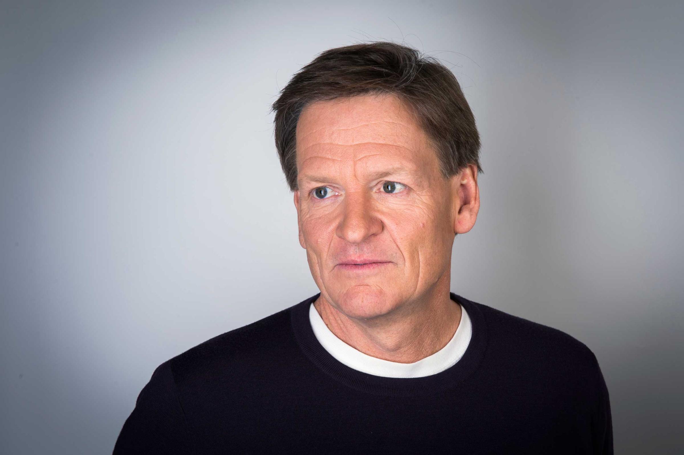 Author Michael Lewis poses for a portrait while promoting his book about high-frequency trading (HFT) named "Flash Boys: A Wall Street Revolt," in New York