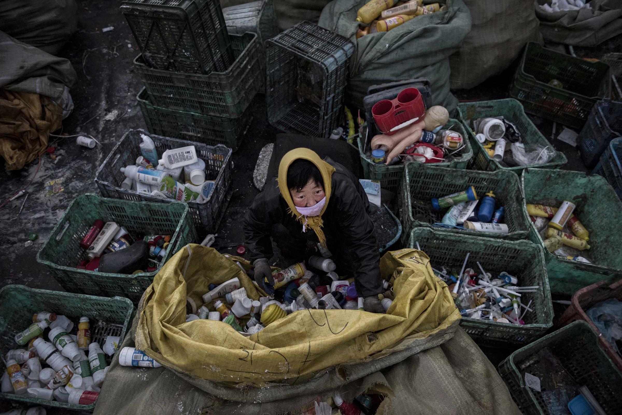 A Chinese laborer sorts plastic before being recycled in the Dong Xiao Kou village on Dec. 15, 2014 in Beijing.