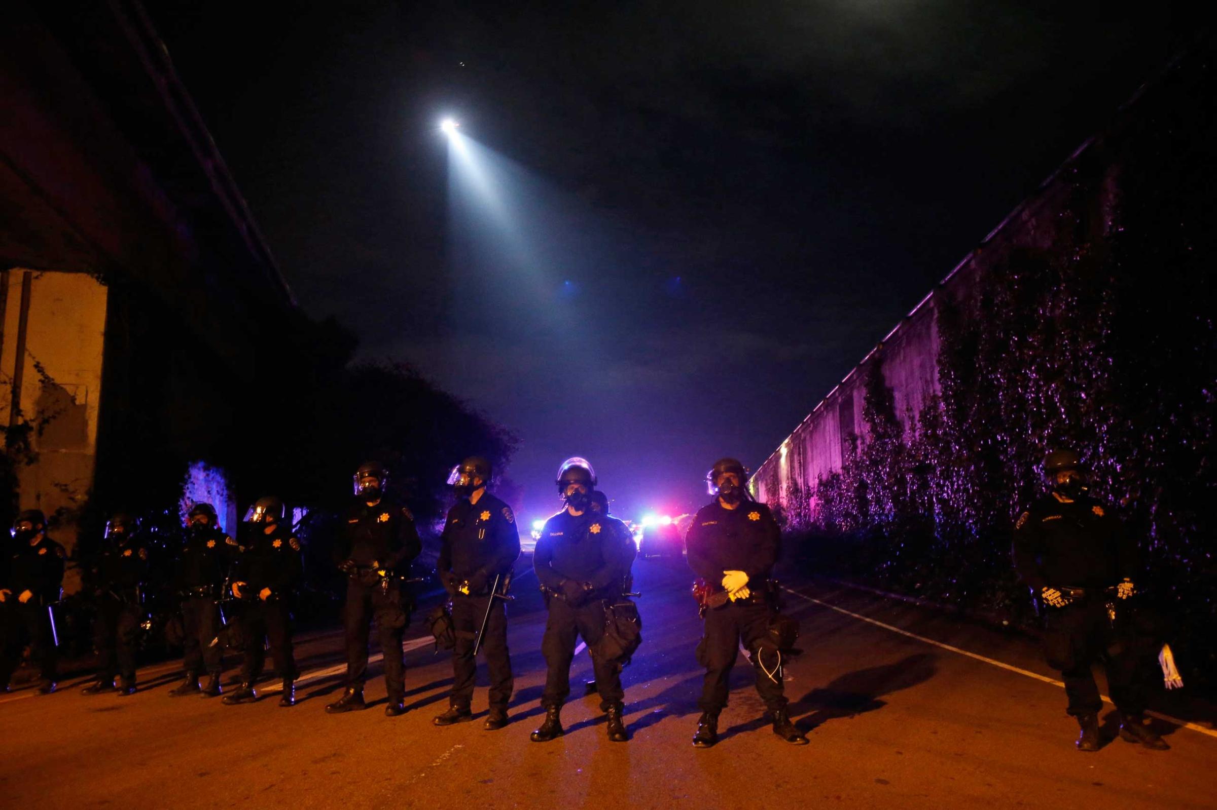 Members of the California Highway Patrol form a line on a freeway entrance after protesters ran onto Highway 24 during a march against the New York City grand jury decision to not indict in the death of Garner in Berkeley