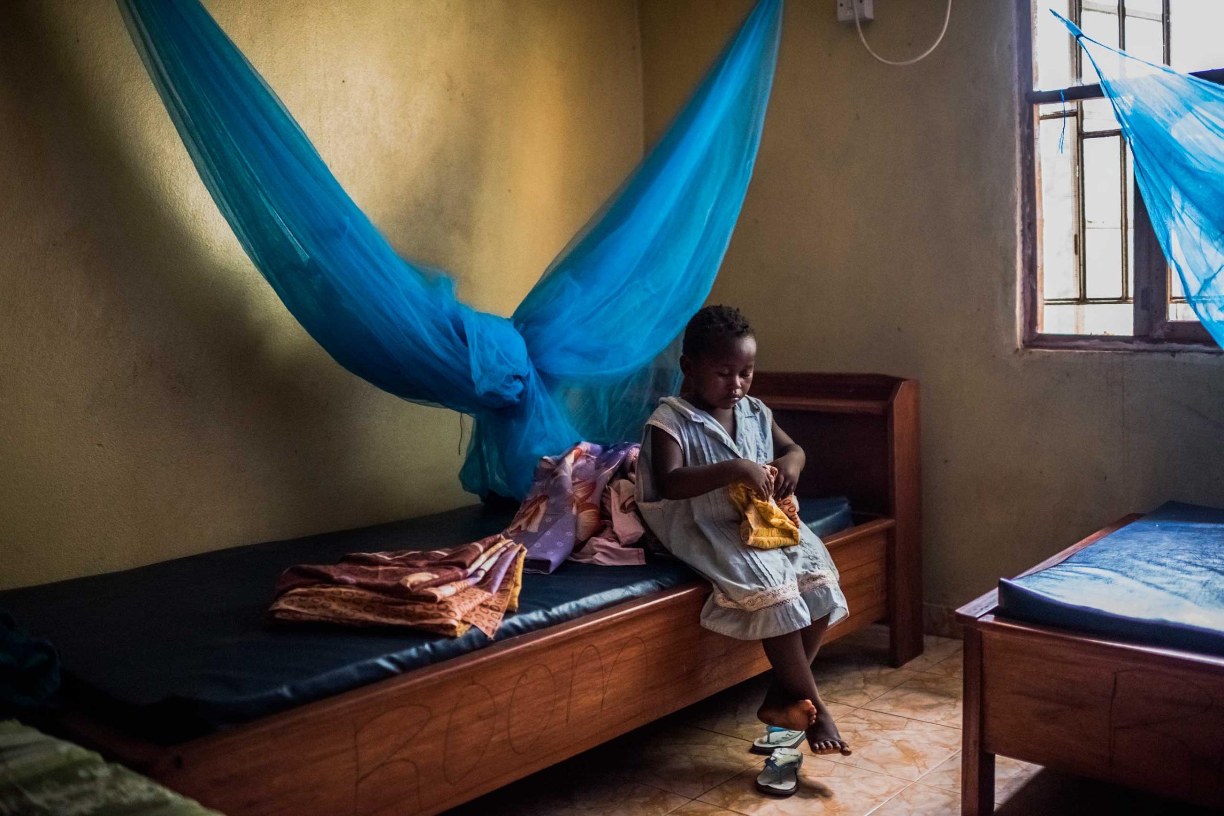 Sweetie Sweetie, believed to be 4, who was orphaned by Ebola, sits in her bedroom at the group home where she now lives in Port Loko, Sierra Leone.