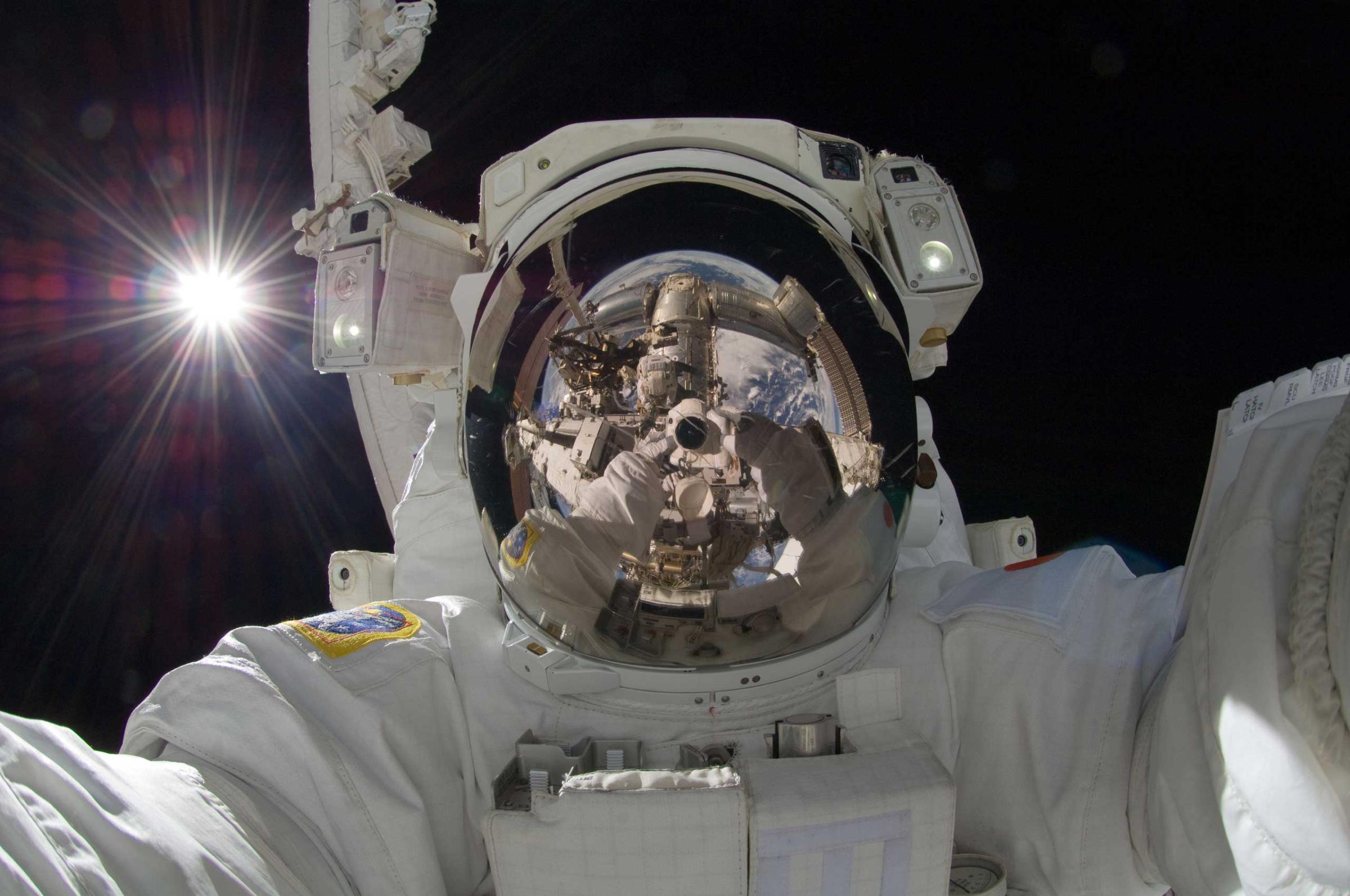 JAXA astronaut Aki Hoshide takes a self-portrait during Expedition 32 in September 2012. “Visible in this outworldly assemblage is the Sun, the Earth, two portions of a robotic arm, an astronaut’s spacesuit, the deep darkness of space, and the unusual camera taking the picture,” NASA wrote. Credit: NASA