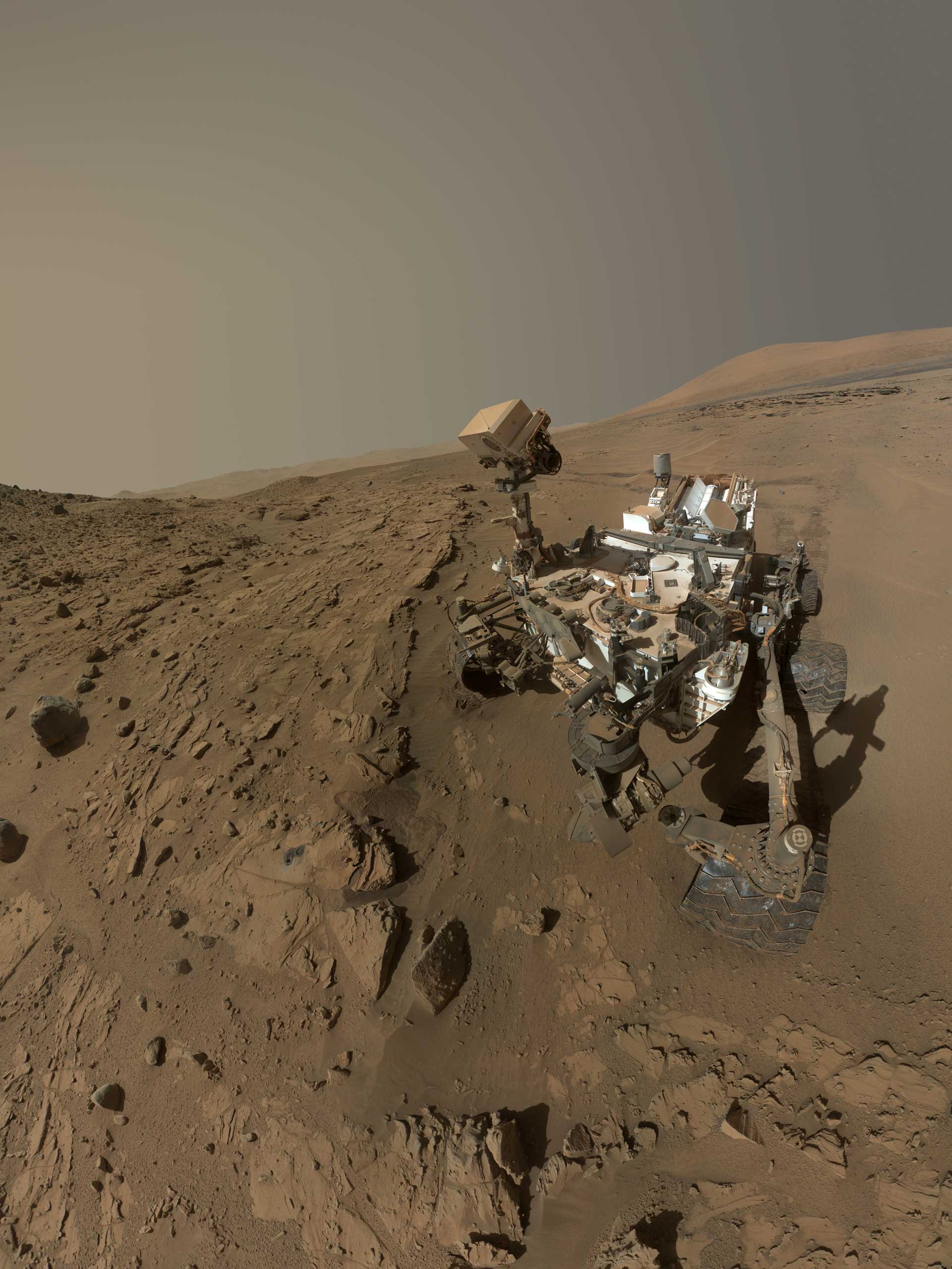 NASA's Curiosity Mars rover used the camera at the end of its arm in April and May 2014 to take dozens of component images combined into this self-portrait where the rover drilled into a sandstone target called "Windjana." The camera is the Mars Hand Lens Imager (MAHLI), which previously recorded portraits of Curiosity at two other important sites during the mission: "Rock Nest" (http://photojournal.jpl.nasa.gov/catalog/PIA16468) and "John Klein" (http://photojournal.jpl.nasa.gov/catalog/PIA16937).Winjana is within a science waypoint site called "The Kimberley," where sandstone layers with different degrees of resistance to wind erosion are exposed close together.The view does not include the rover's arm. It does include the hole in Windjana produced by the hammering drill on Curiosity's arm collecting a sample of rock powder from the interior of the rock. The hole is surrounded by grayish cuttings on top of the rock ledge to the left of the rover. The Mast Camera (Mastcam) atop the rover's remote sensing mast is pointed at the drill hole. A Mastcam image of the drill hole from that perspective is at http://mars.jpl.nasa.gov/msl/multimedia/raw/?rawid=0626MR0026780000401608E01_DXXX&amp;s=626. The hole is 0.63 inch (1.6 centimeters) in diameter. The rover's wheels are 20 inches (0.5 meter) in diameter.Most of the component frames of this mosaic view were taken during the 613th Martian day, or sol, of Curiosity's work on Mars (April 27, 2014). Frames showing Windjana after completion of the drilling were taken on Sol 627 (May 12, 2014). The hole was drilled on Sol 621 (May 5, 2014).MAHLI was built by Malin Space Science Systems, San Diego. NASA's Jet Propulsion Laboratory, a division of the California Institute of Technology in Pasadena, manages the Mars Science Laboratory Project for the NASA Science Mission Directorate, Washington. JPL designed and built the project's Curiosity rover.&gt; NASA’s Mars Curiosity Rover Marks First Martian Year with Mission Suc