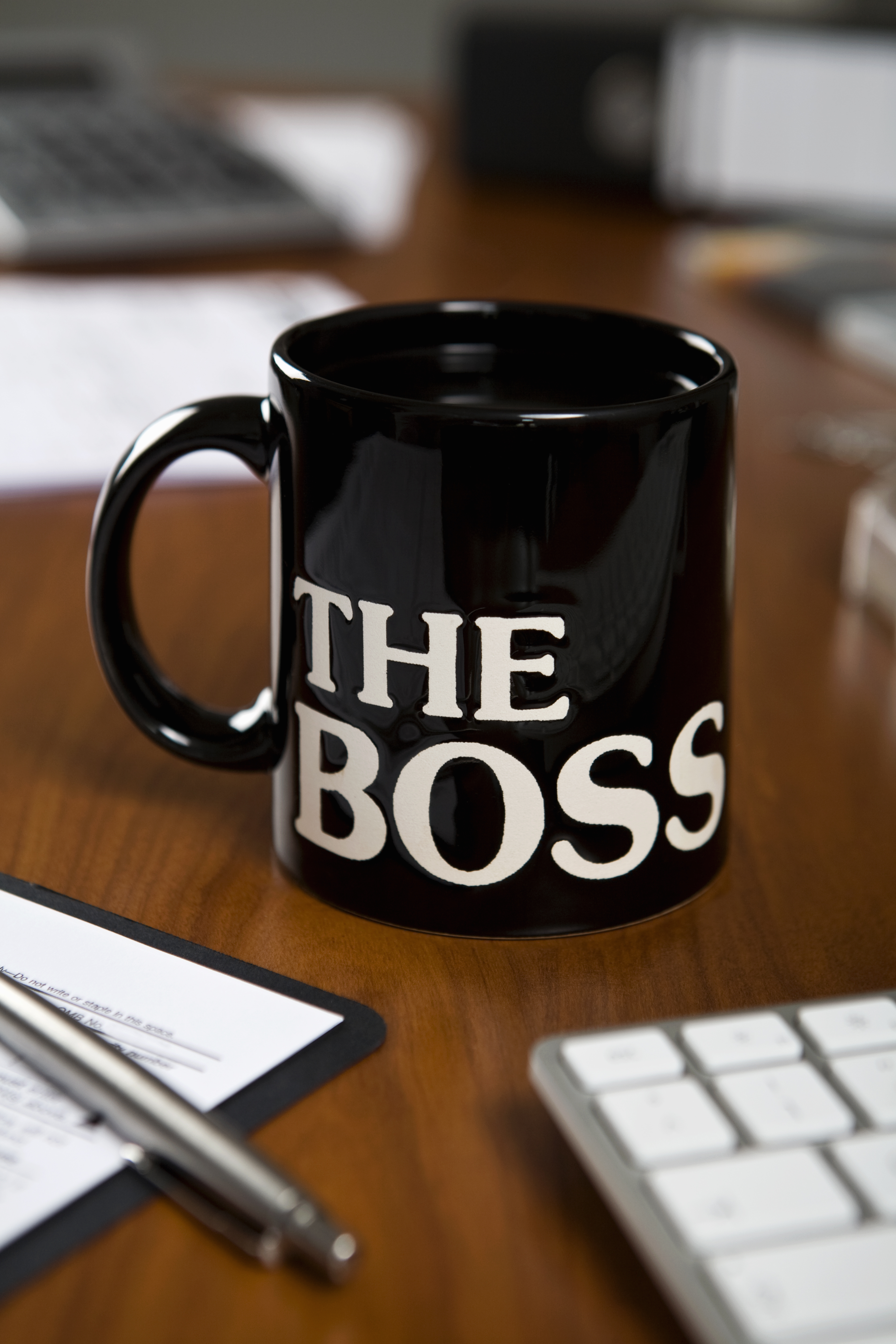 The Boss mug on a desk